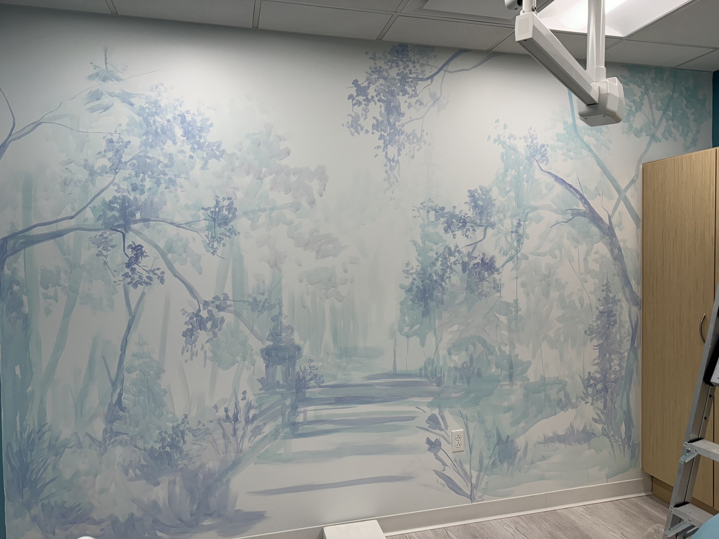 Mural of garden with trees in several different shades of blue at Kid's Smiles Pediatric Dentist - Exam Room