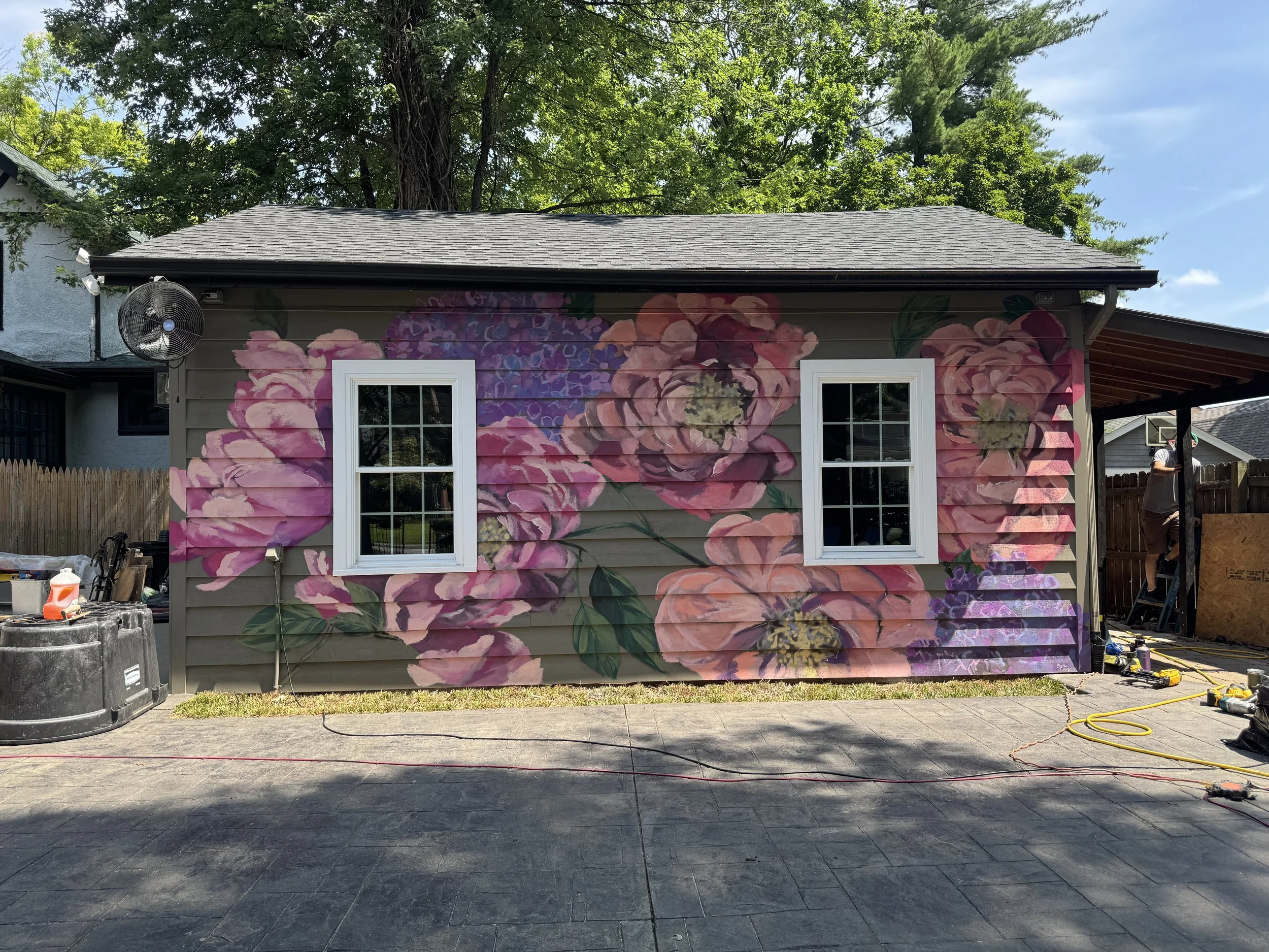 Outdoor mural of flowers on the side of a building