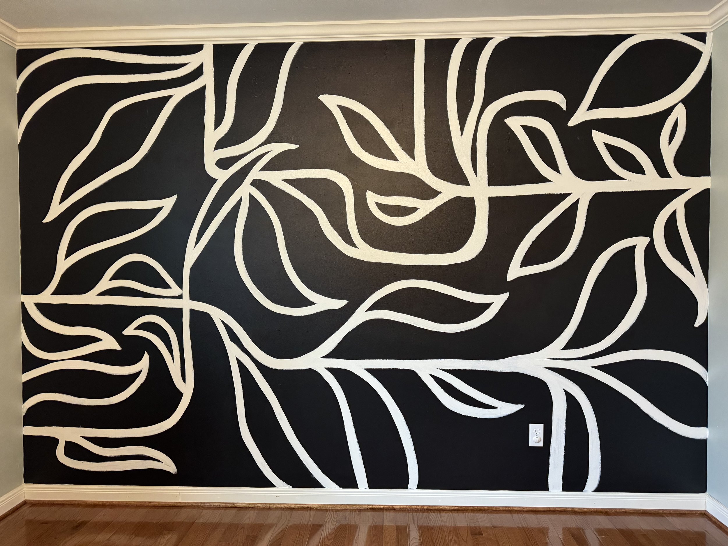 Black and white mural of leaves in a line art style