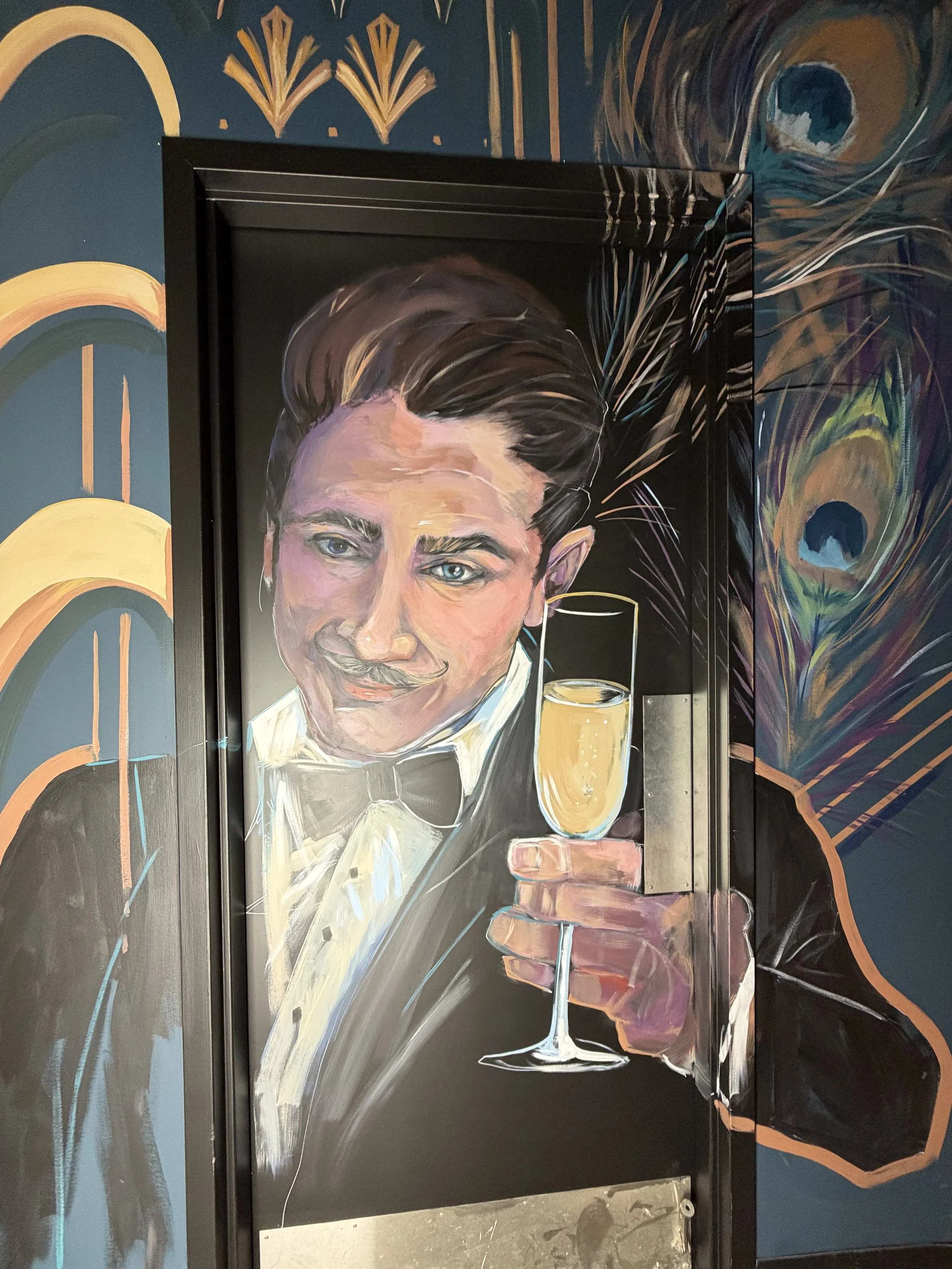 Mural of a man wearing a tuxedo holding up a champagne flute