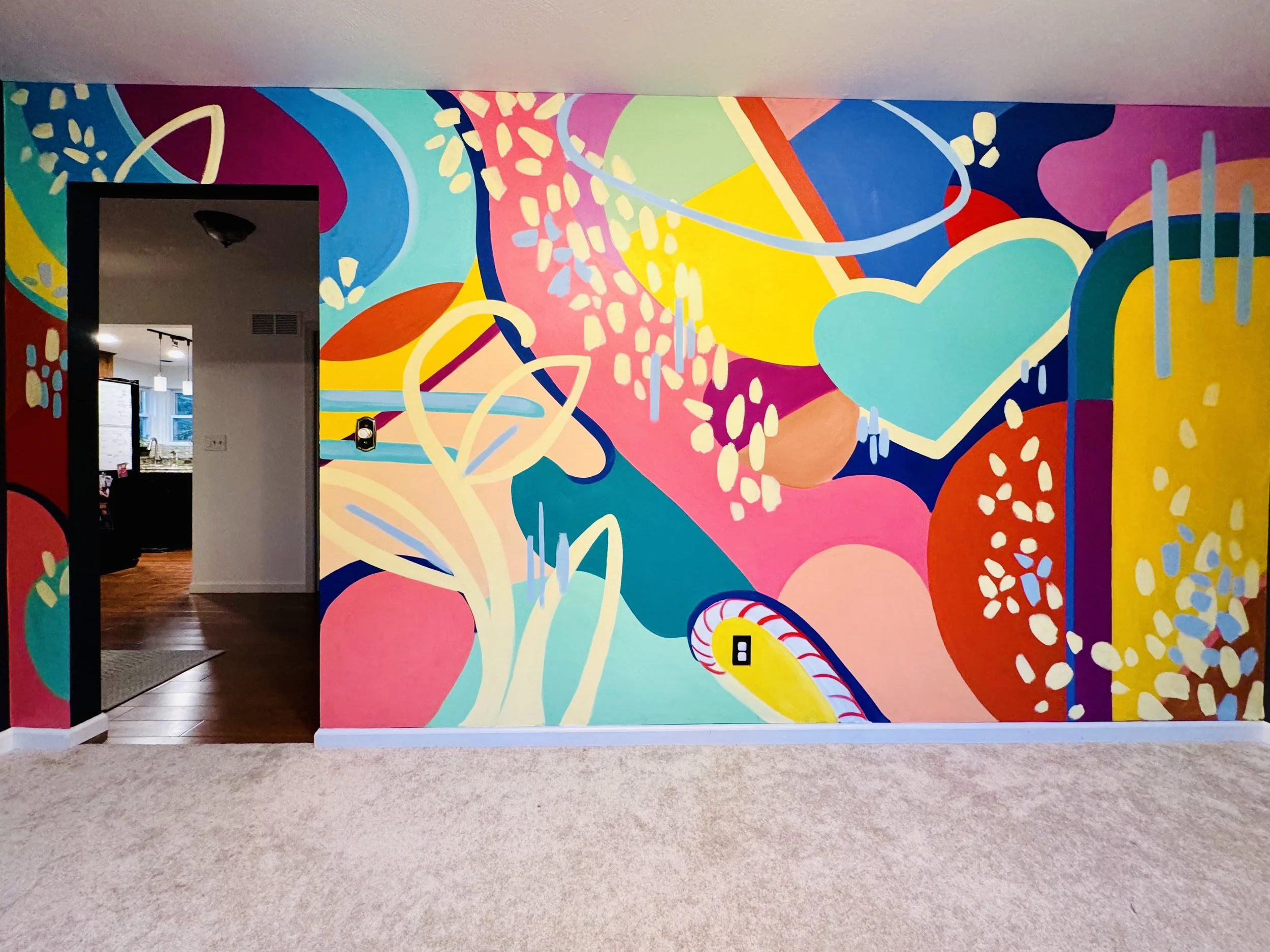Colorful bright mural in a residential playroom with organic shapes