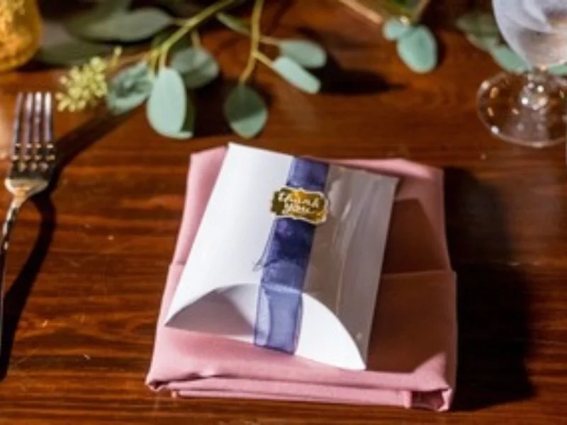 a white wedding favor with a thank you note