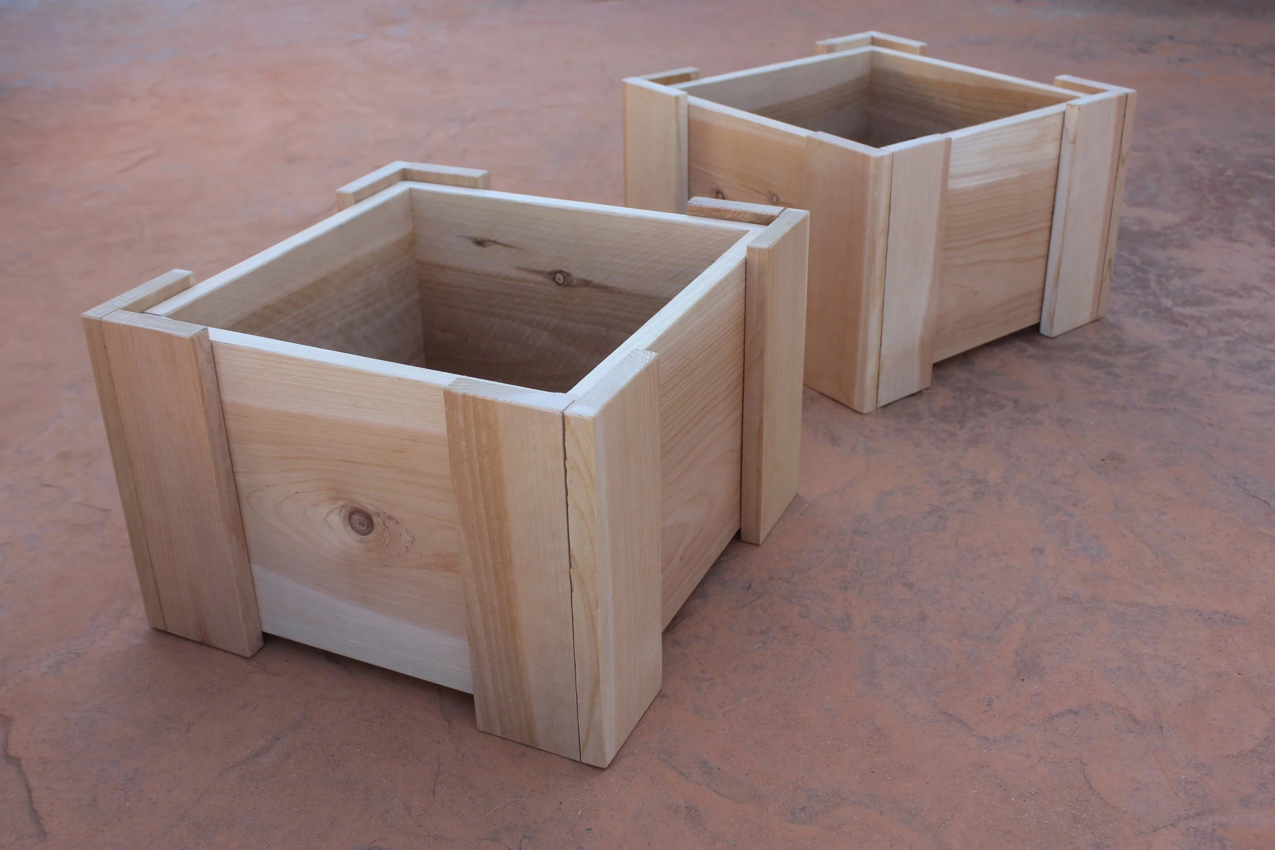 Two cedar mini planter boxes against a patio background.