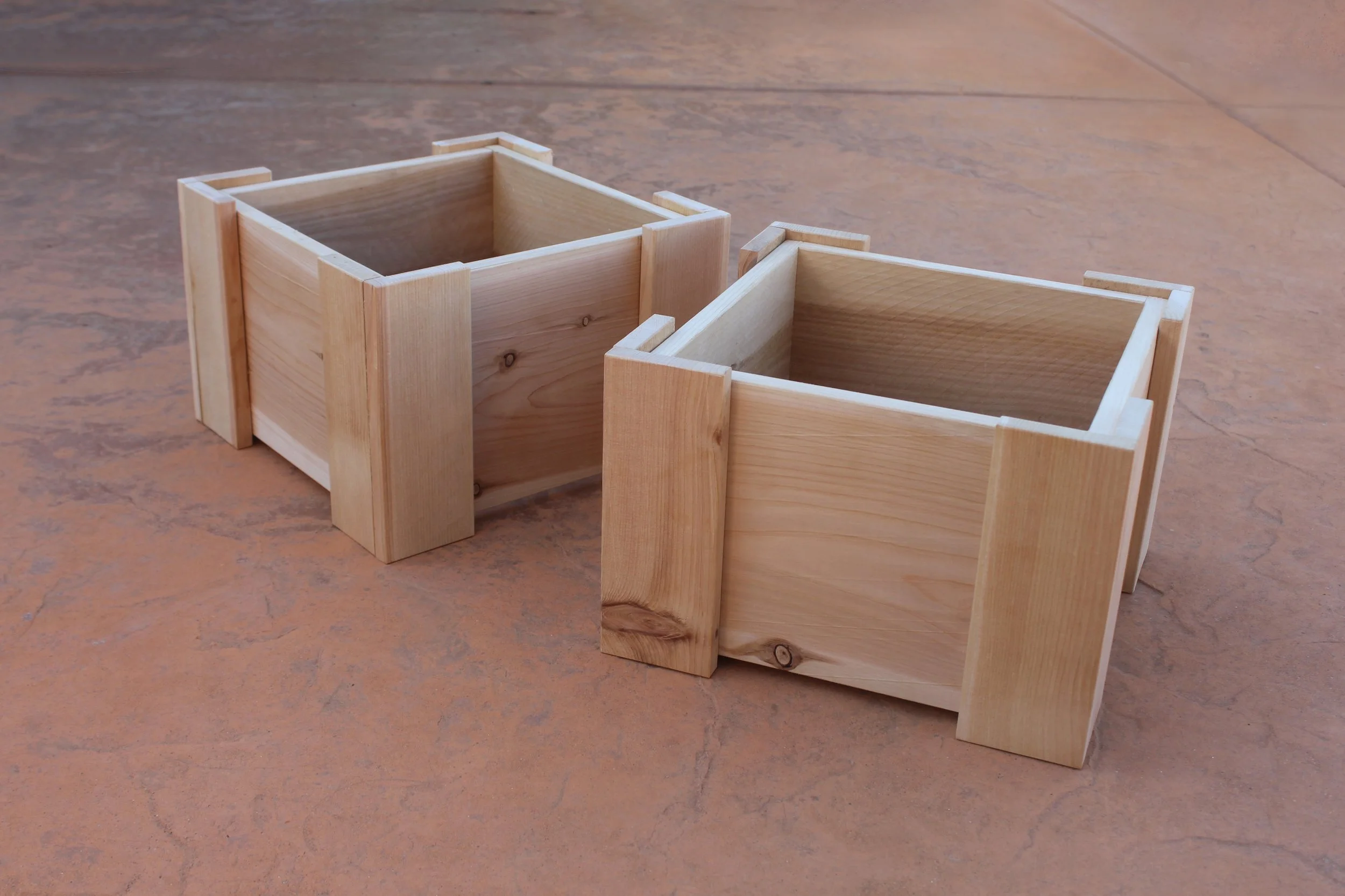 Two cedar mini planter boxes against a patio background.
