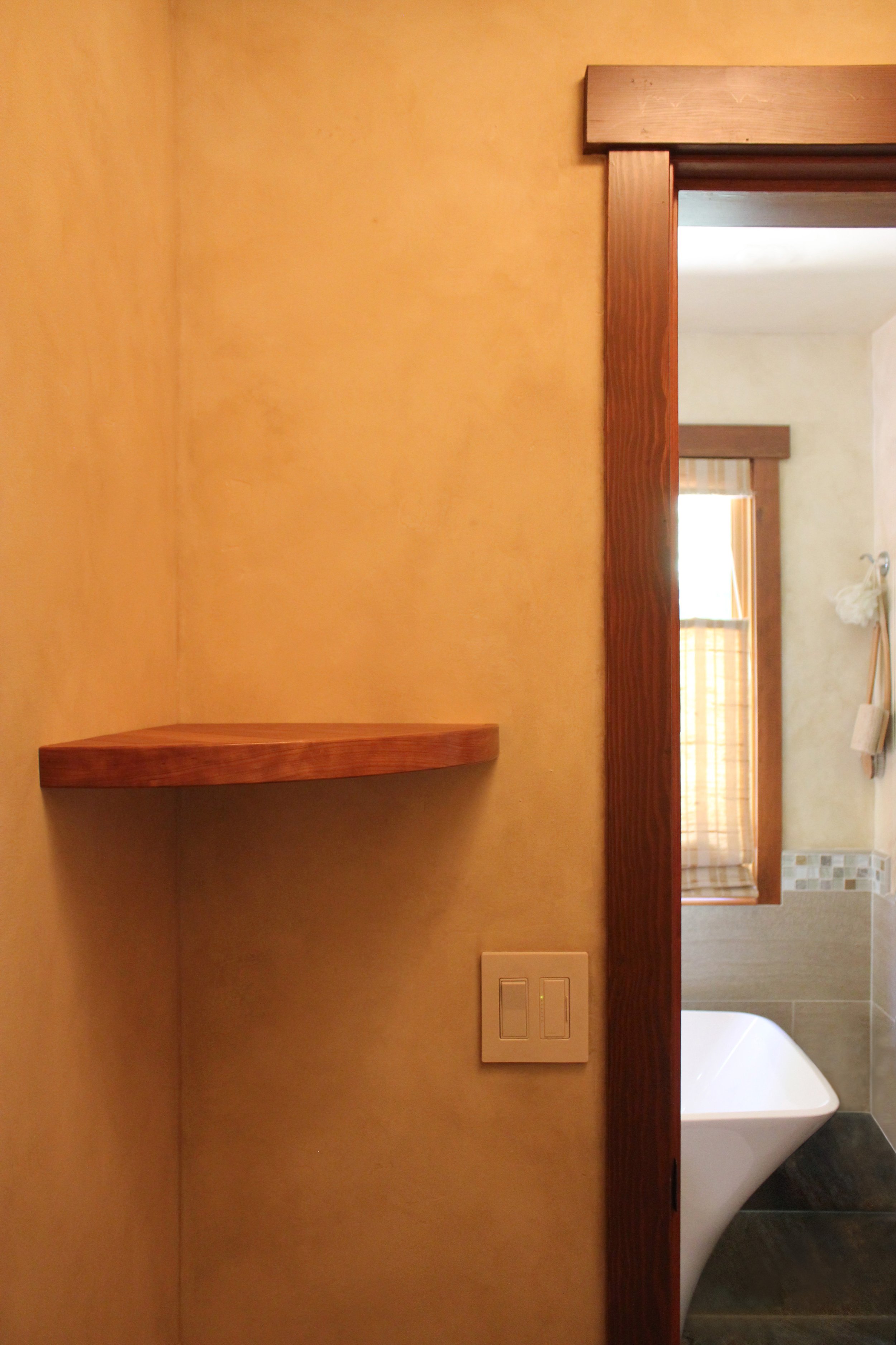floating corner shelf shown in cherry with a natural, oil based finish. available in black walnut, white oak, maple, cherry, elm, ash and teak wood, and custom inquiries are always welcome.