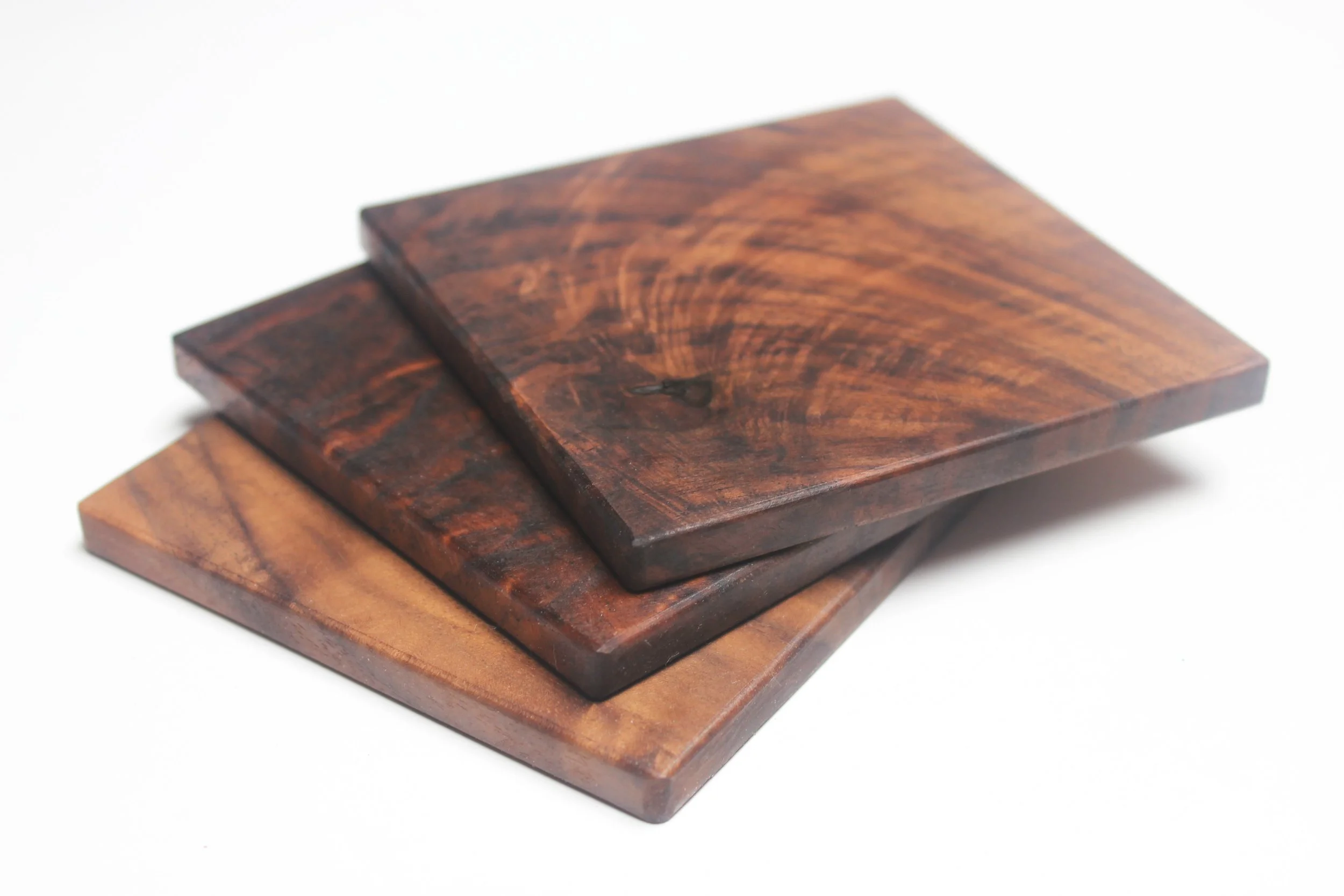 Handmade, solid wood coasters shown in black walnut.