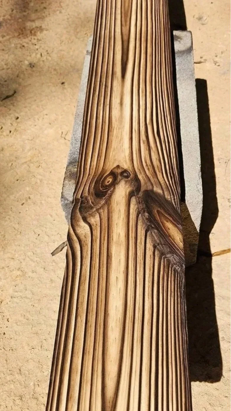Close-up of wood grain and knots revealed during FireForged™ resurfacing.