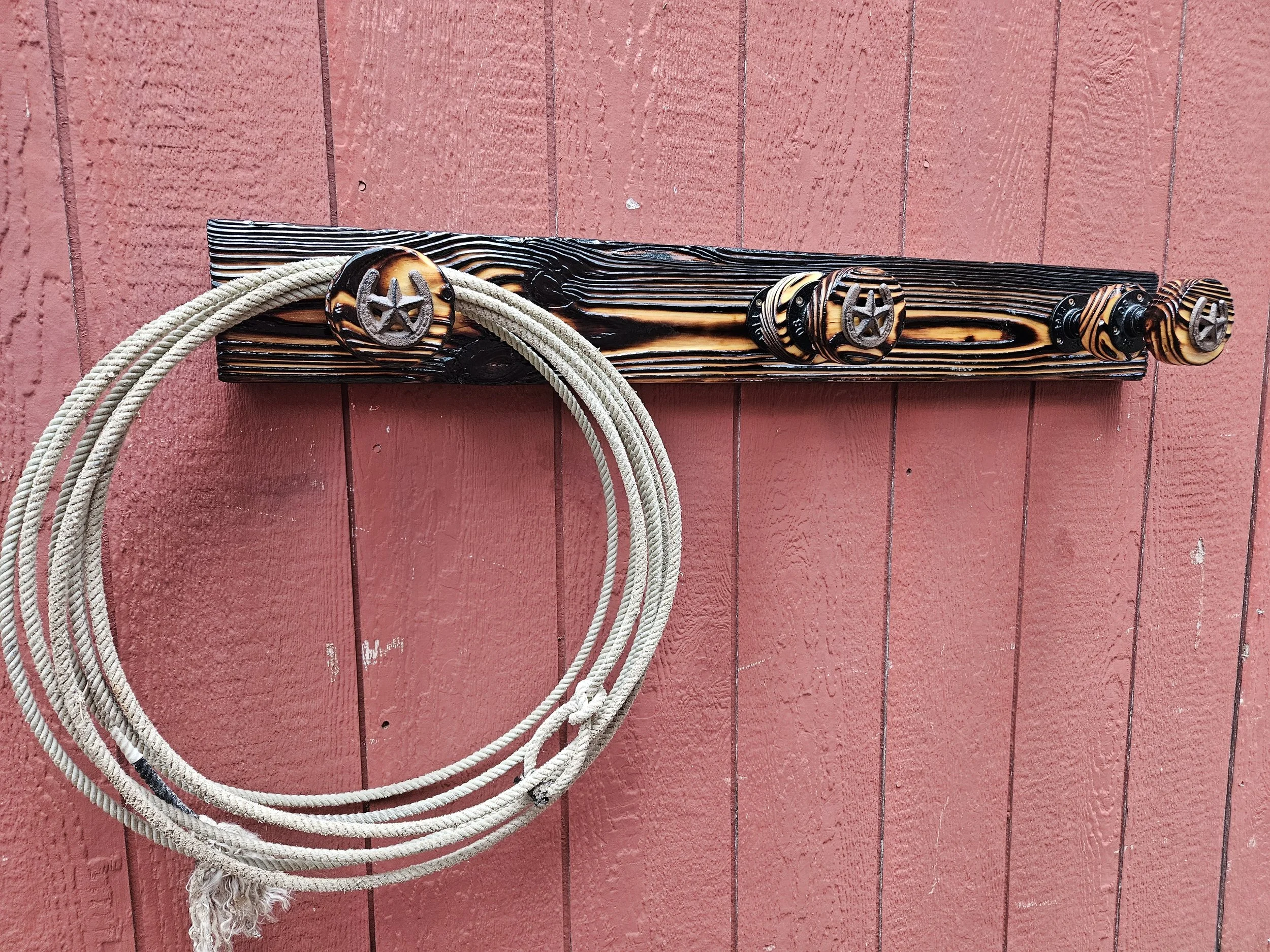 A wooden wall with a climbing rope attached to it.