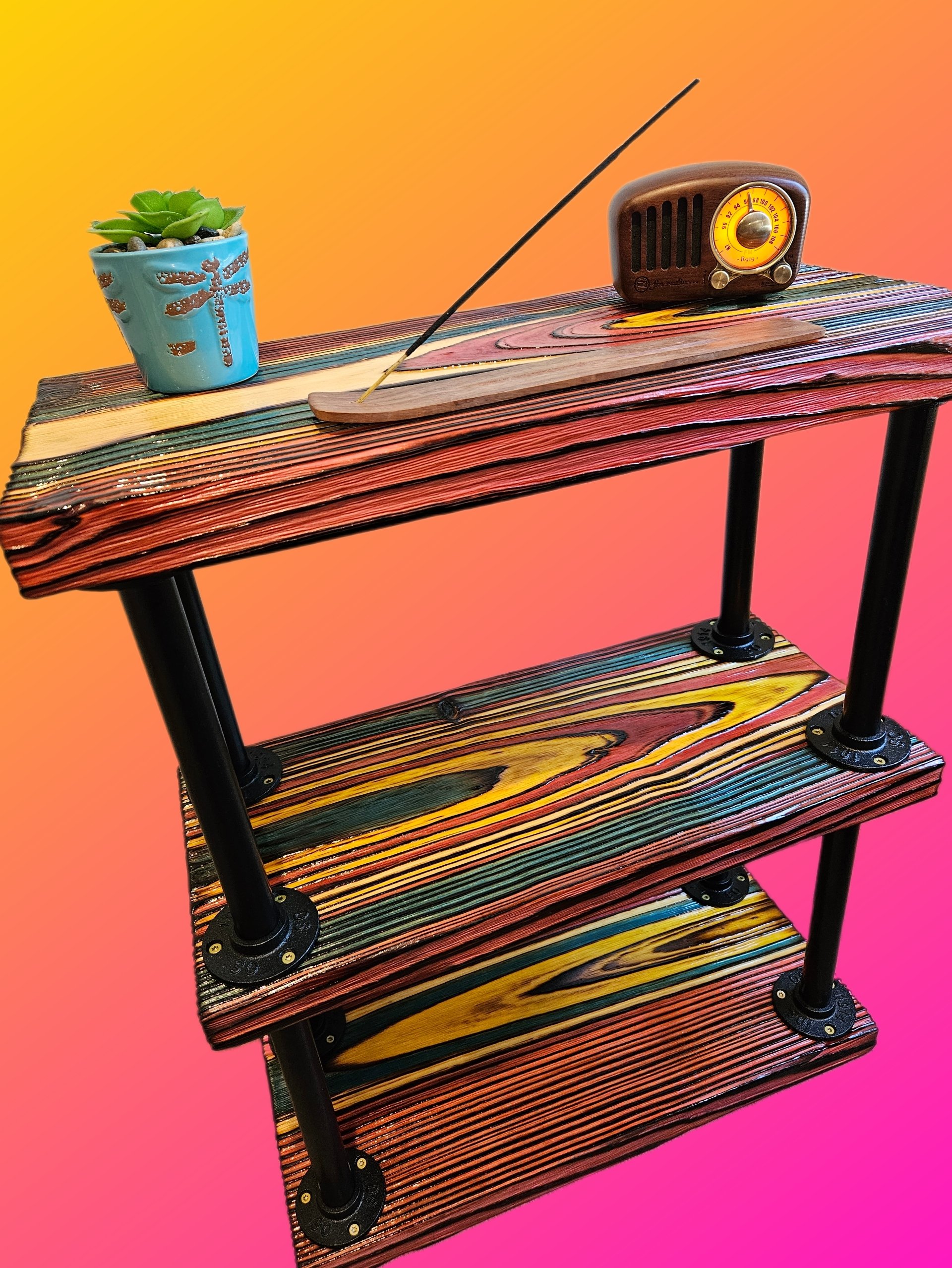 A three-tier wooden shelf with metal legs, a small blue pot with a succulent plant, and a vintage brown radio against a colorful background.