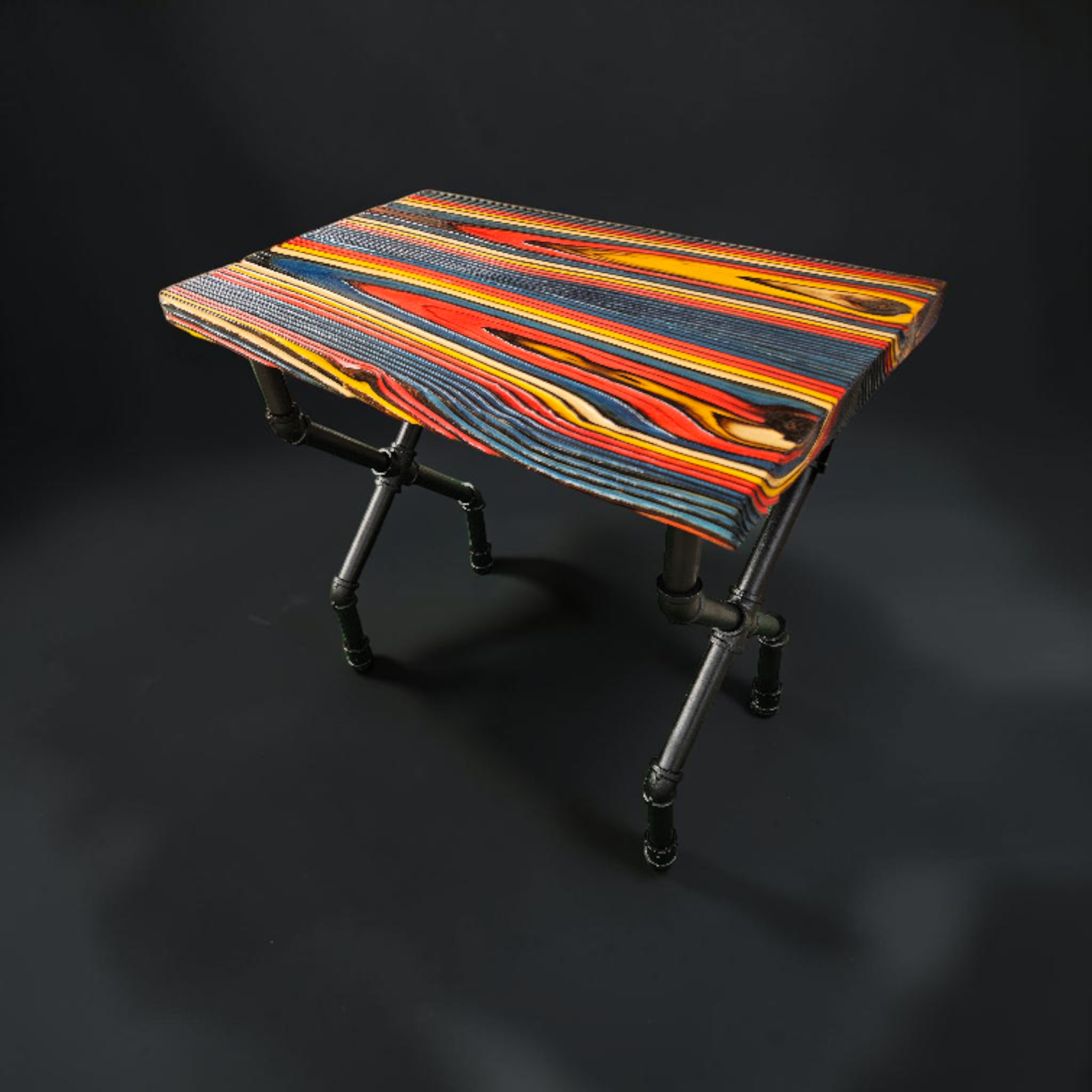 FireCandy™ X-Design Accent Table with a colorful FireForged™ top and black industrial-style legs.
