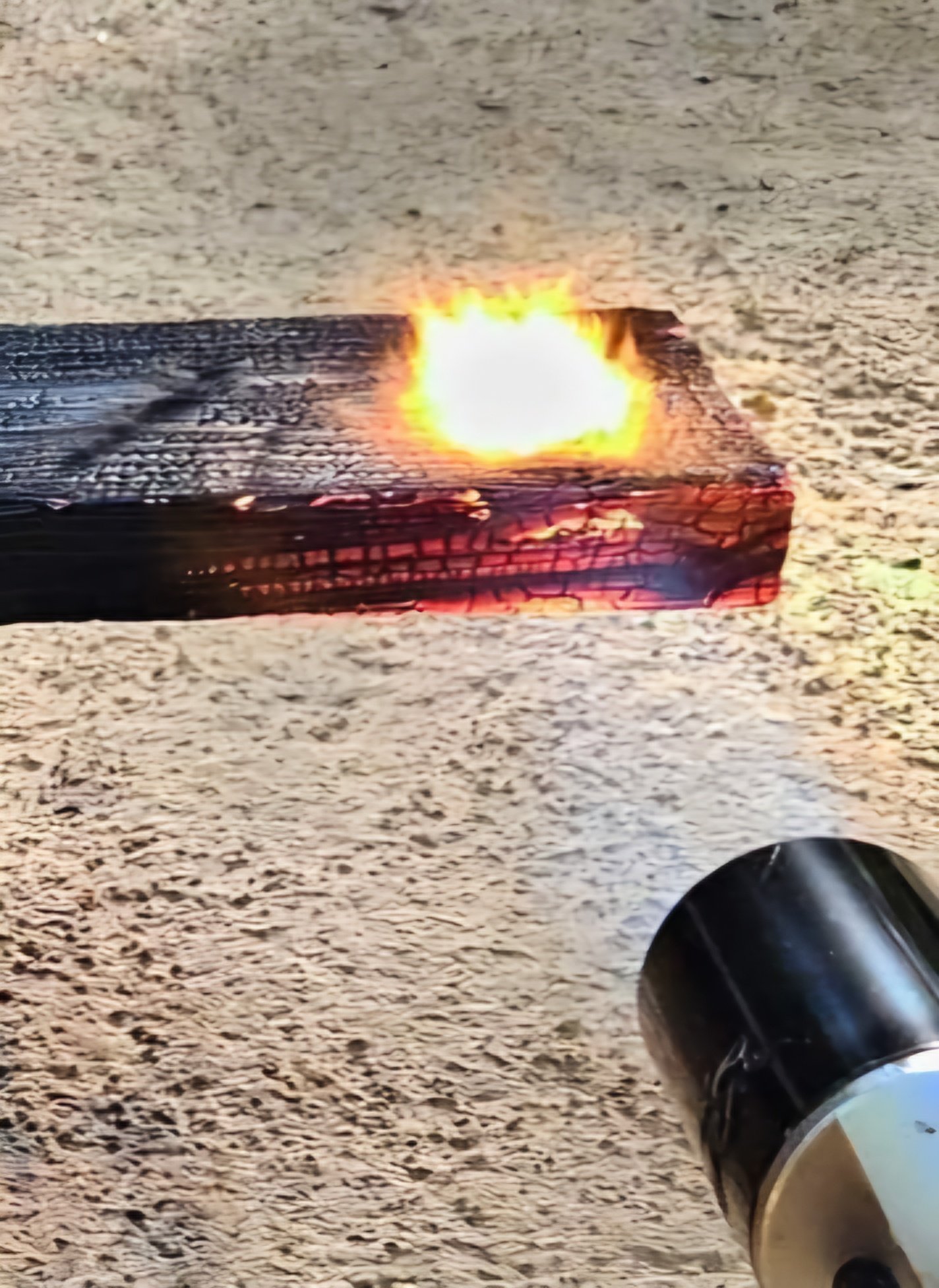 A controlled torch flame applied to wood during the FireForged™ process.