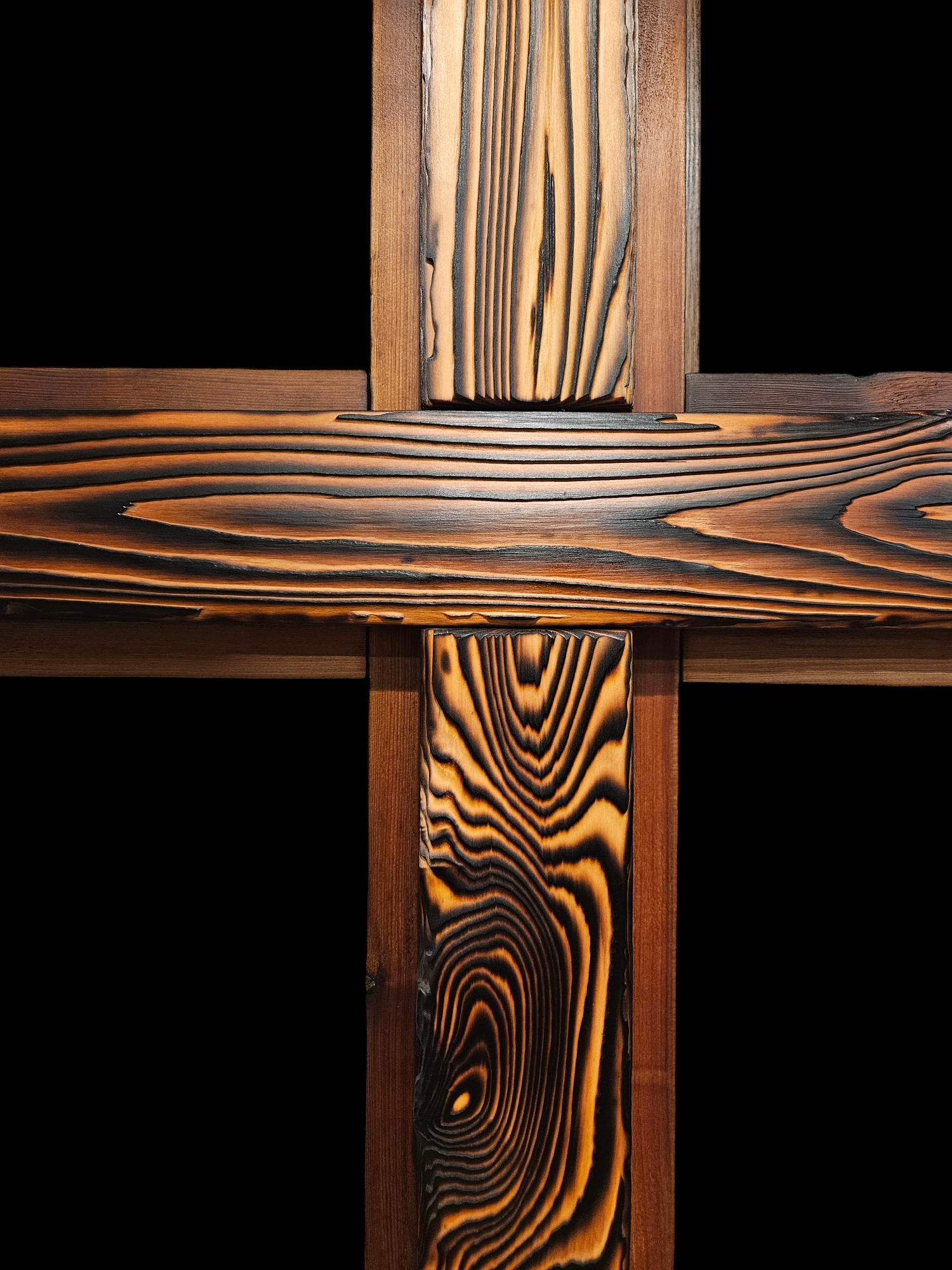 Close-up of wooden furniture or flooring with dark and light wood grain patterns.