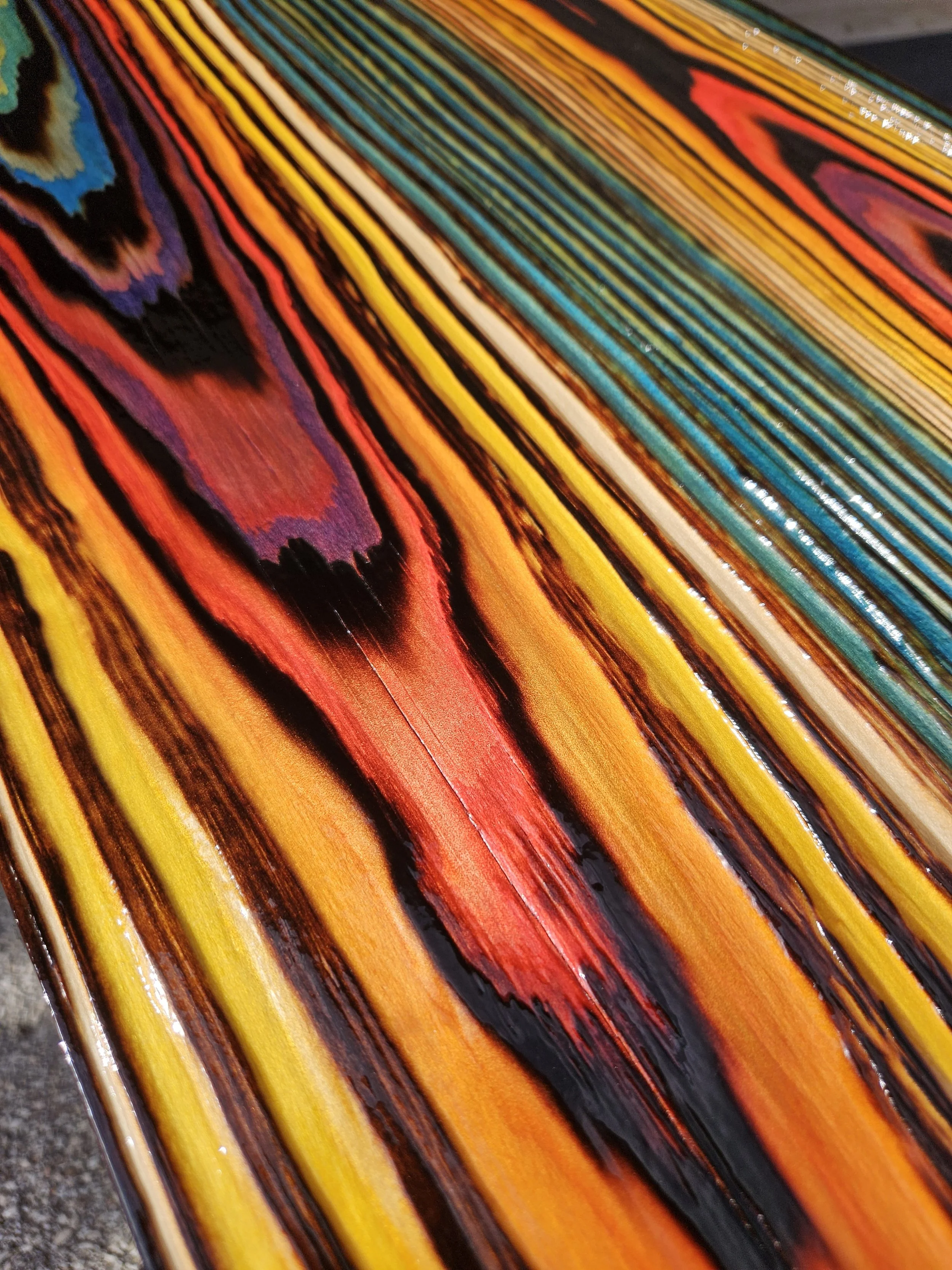 Close-up of a FireCandy™ finish showing vivid transparent color across raised wood grain.