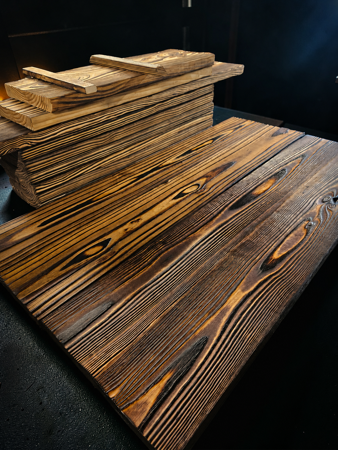 Stacked FireForged™ Maker Boards showing distinctive raised grain and handcrafted finishes.