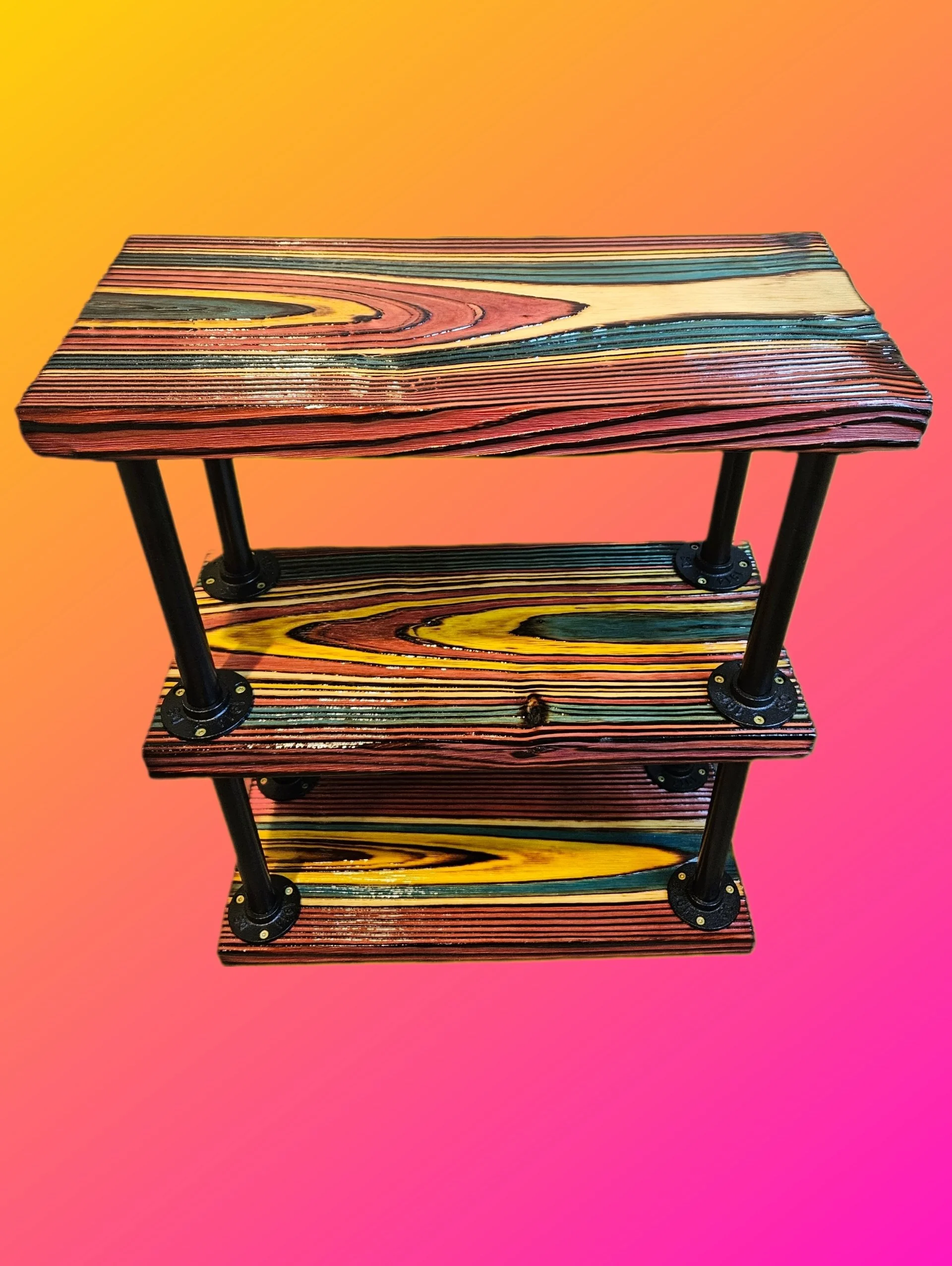A wooden three-tiered shelf with black metal frame and round black metal connectors, set against a gradient background from yellow to pink.