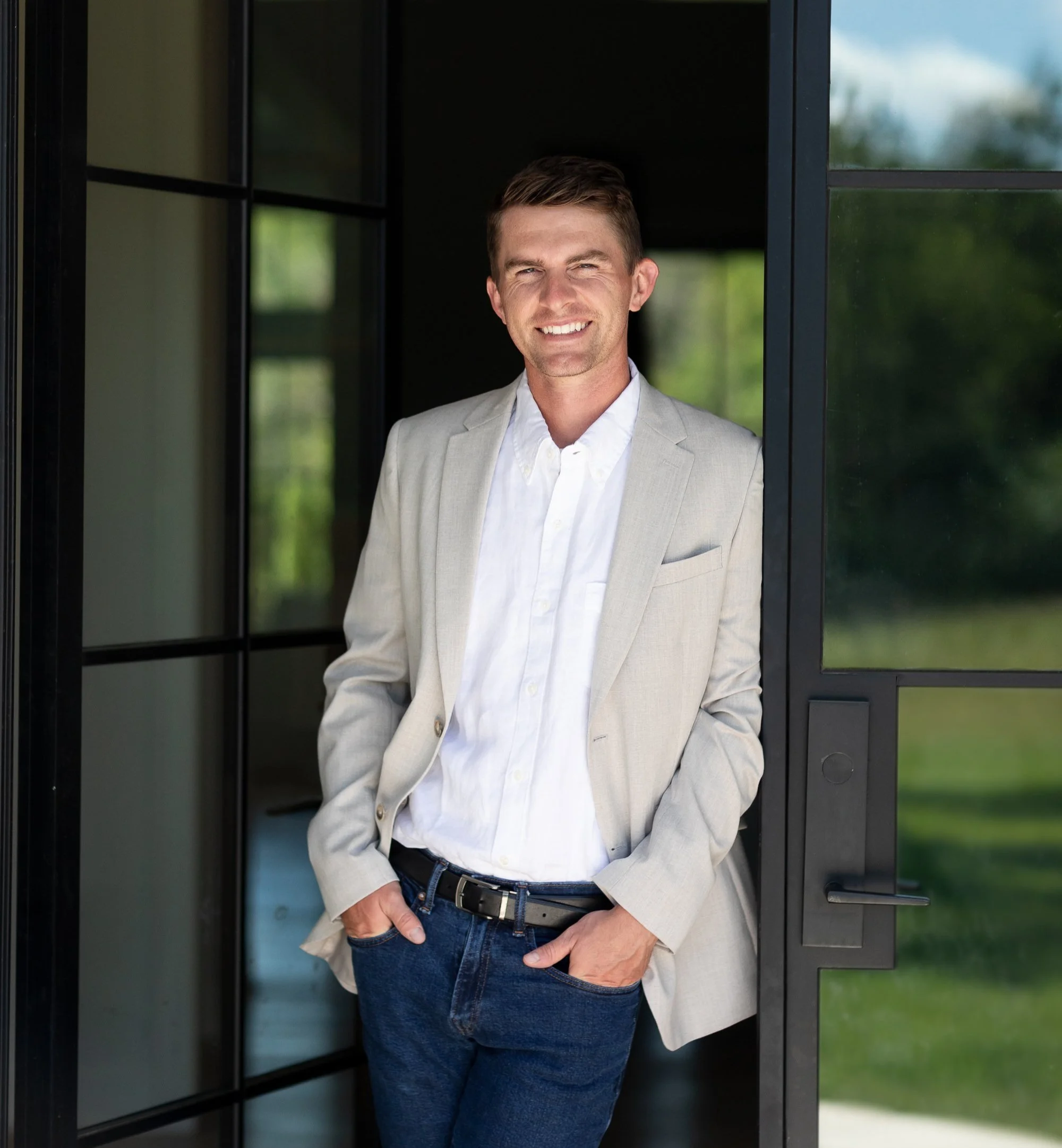 Bennett Arey standing in the front entrance of a new build home.