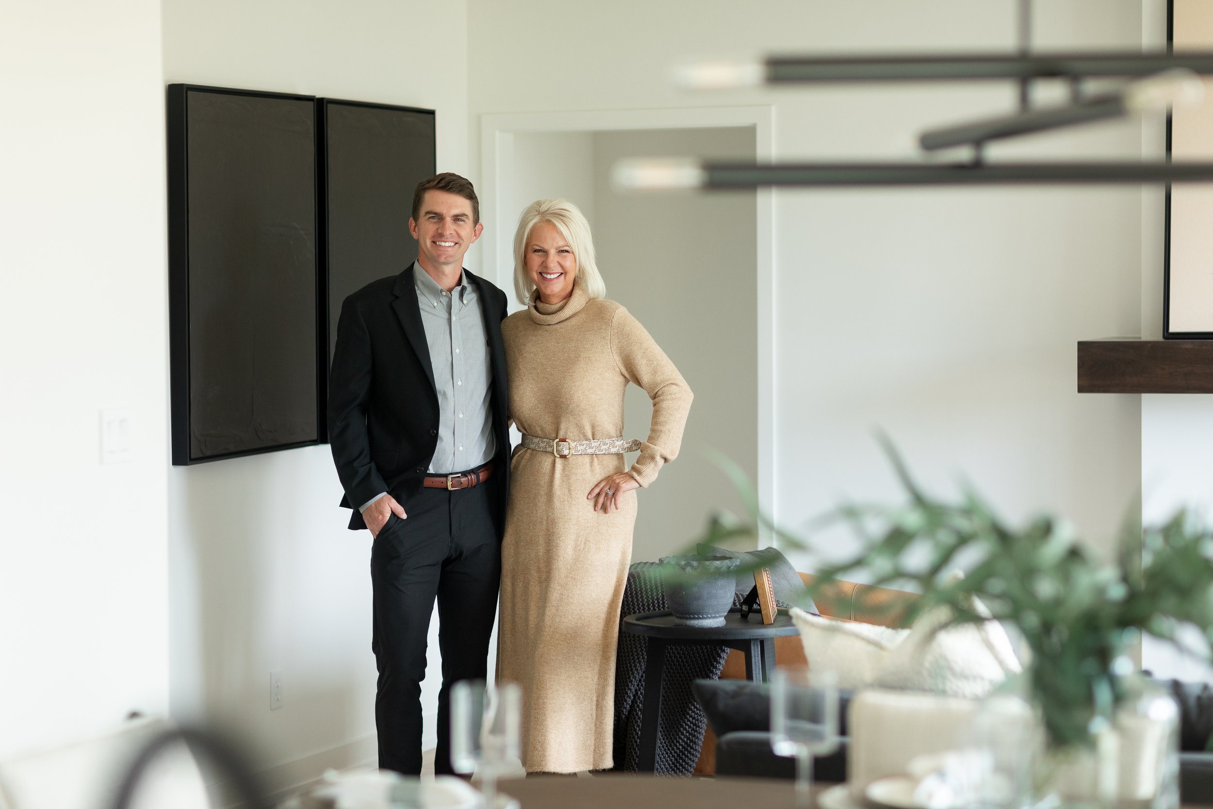Beth and Bennett Arey standing in the livingroom for a new construction, new listing home in Columbia Missouri.