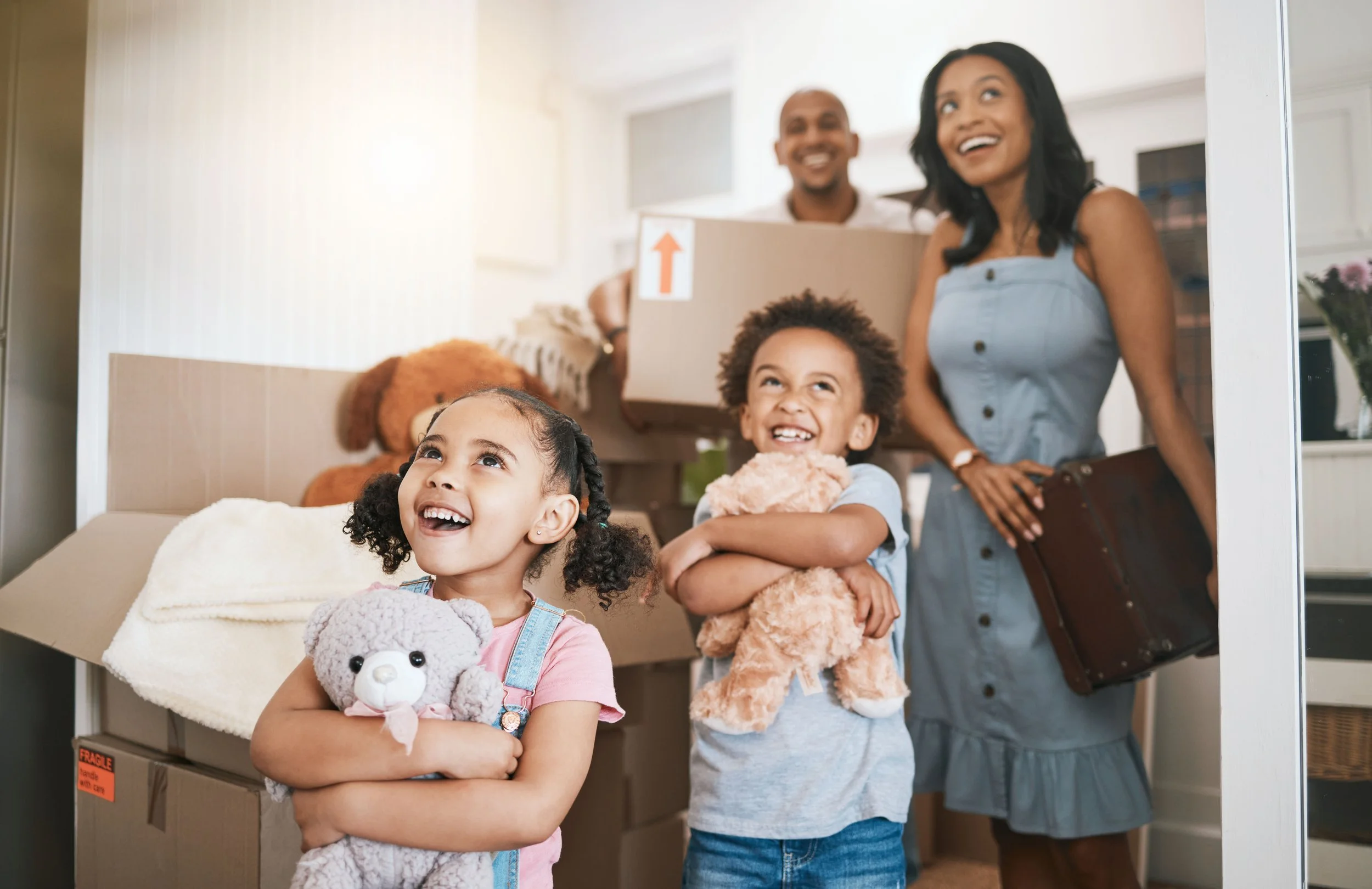 A family moving into their new home with moving boxes.
