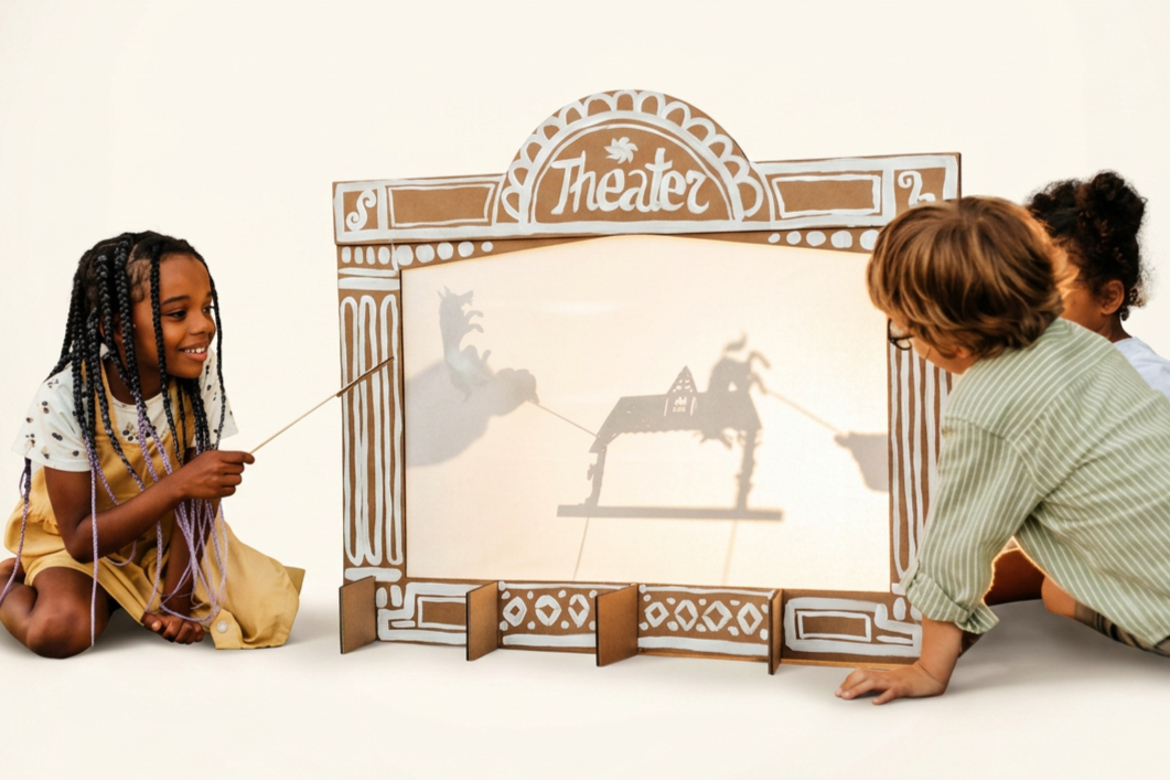 Children create a shadow puppet show with homemade materials.