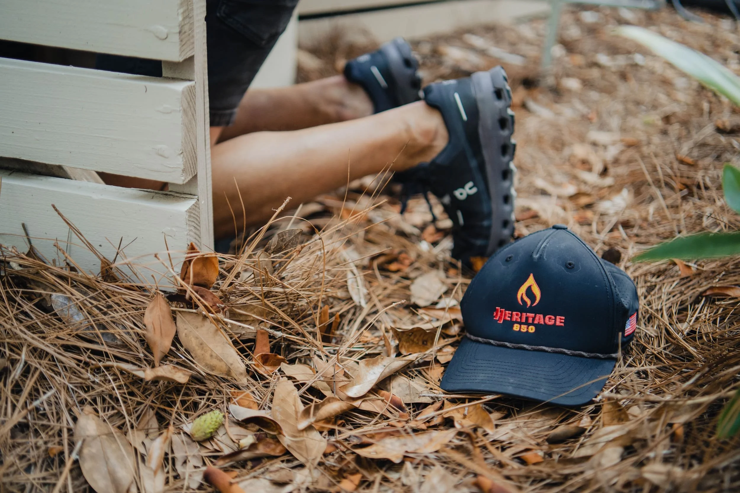plumber kneeling in crawl space for leak repair
