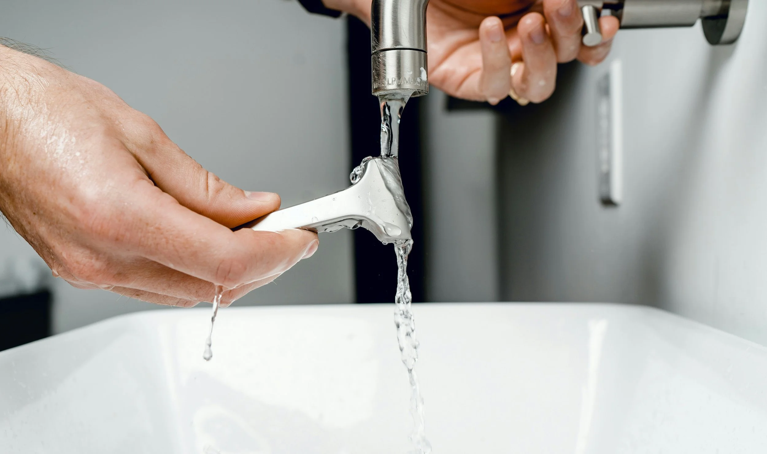 running faucet with plumbing tools