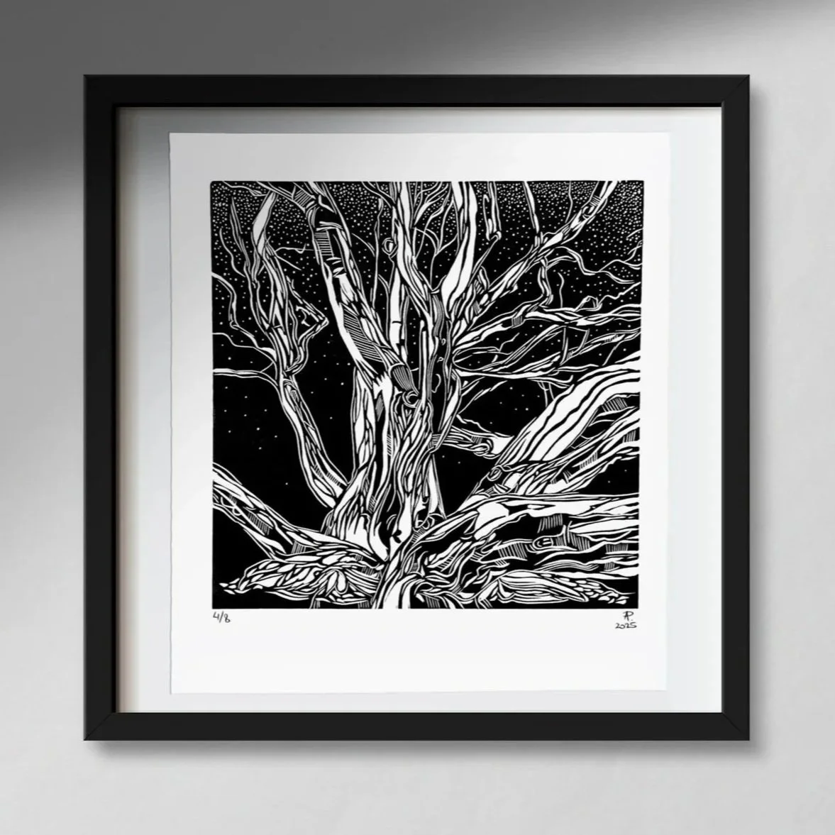 Black and white artwork of a large tree with intricate, flowing branches, set against a starry night sky, framed in black.