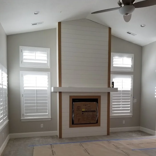 Custom shiplap fireplace surround with a floating mantel installed by CBR Interiors in a Utah home. The feature wall extends to the vaulted ceiling and is designed to complement the home's modern architecture.