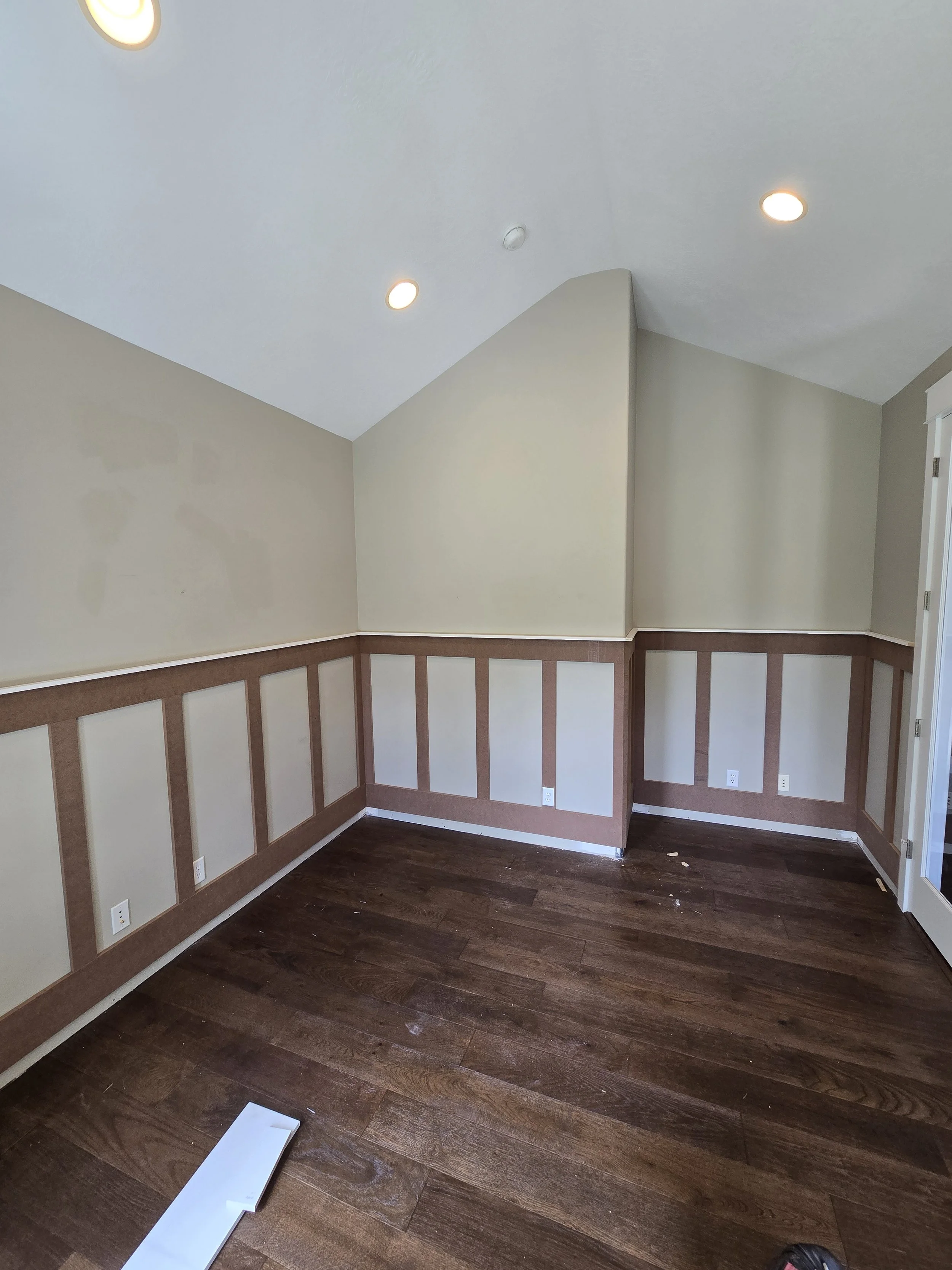 Custom board and batten wall paneling installed by CBR Interiors in a Utah home office. The wall trim wraps continuously around the room, creating a clean and cohesive architectural detail.
