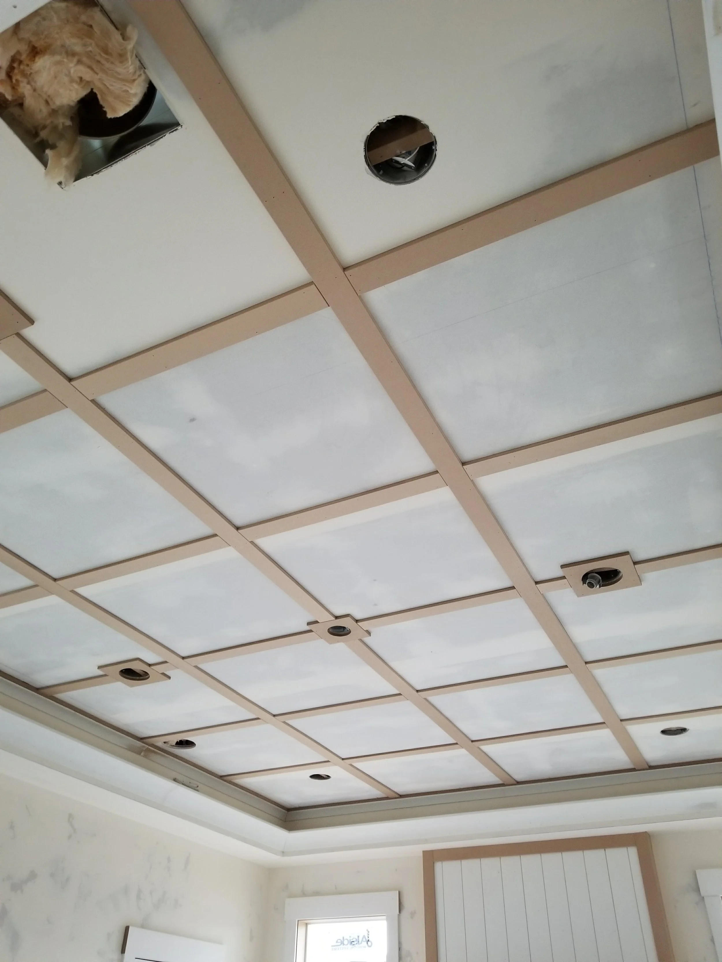 Custom decorative grid ceiling installed by CBR Interiors in a Utah home. The ceiling layout was carefully planned around recessed lighting and room dimensions to create clean, consistent spacing throughout.