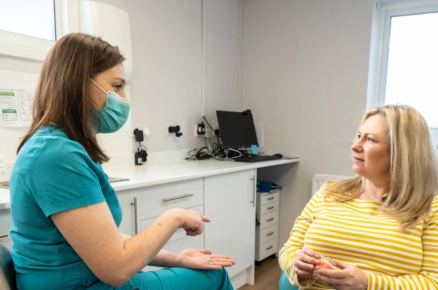 Dr Steph Durham with a patient, explaining Invisalign