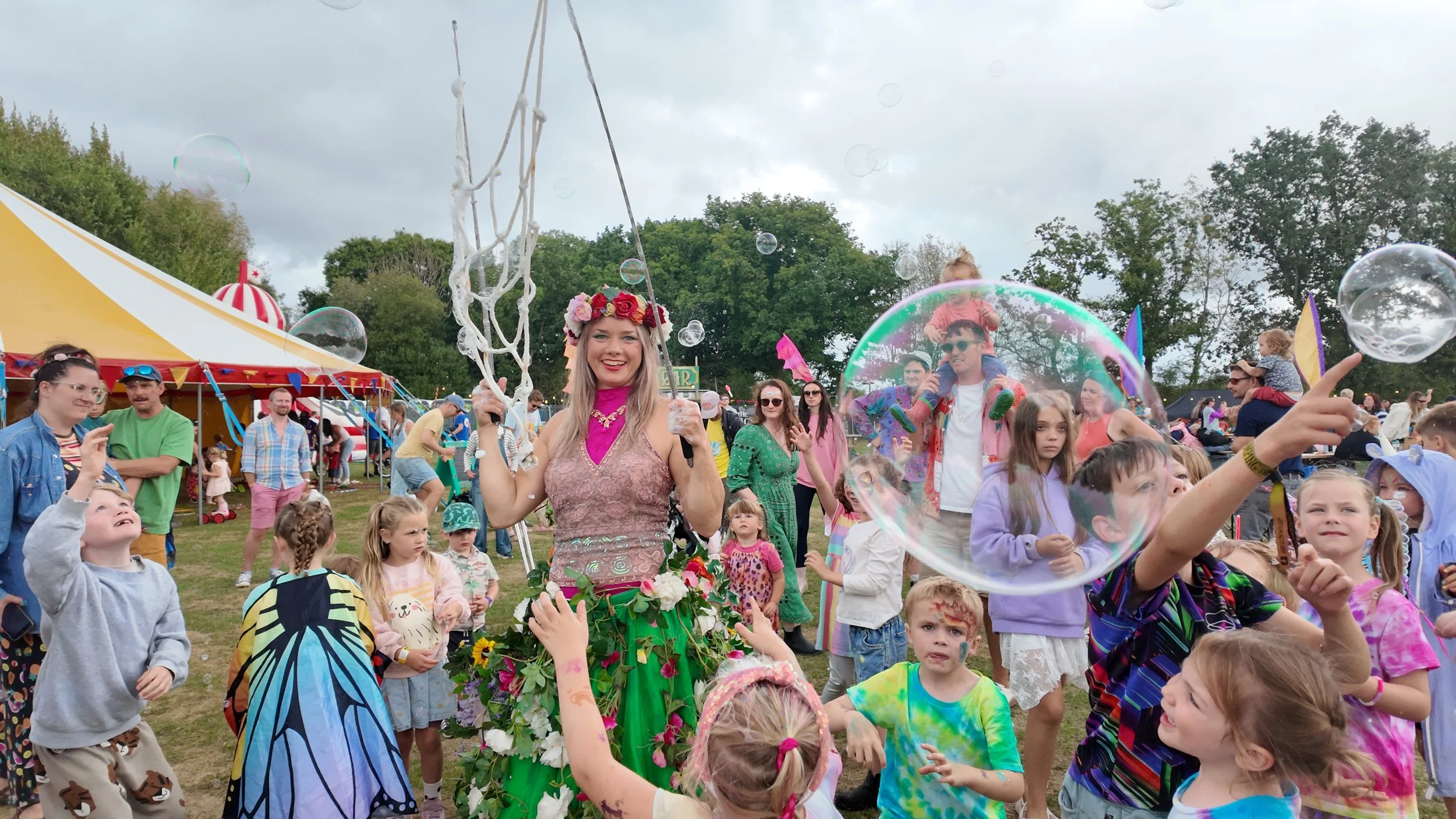 a female performer at an outdoor event with bubbles