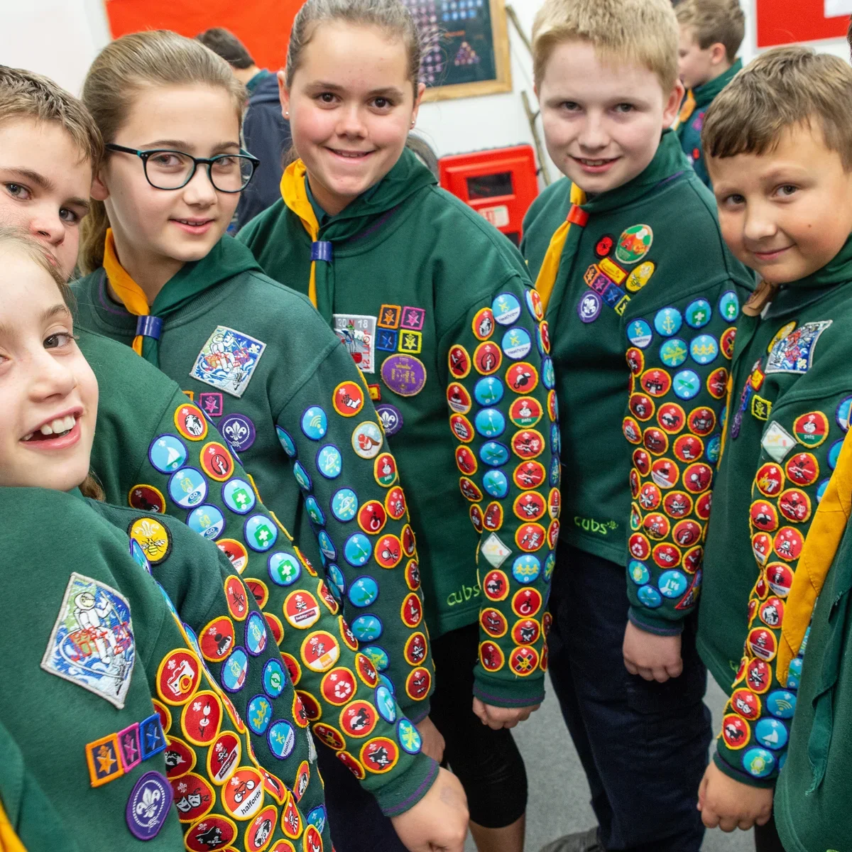 Group of cubs showing all their badges on their left arms