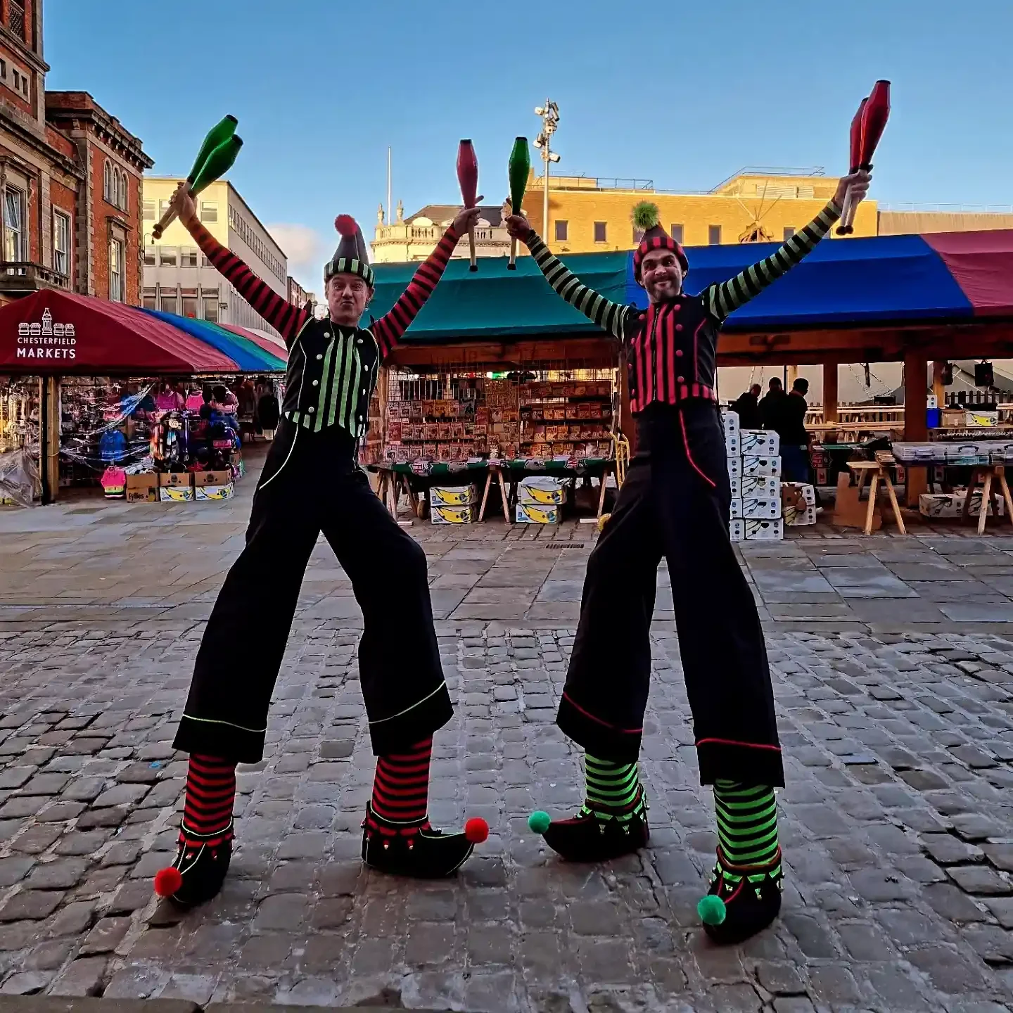 2 walkabout performers dressed as elves on stilts