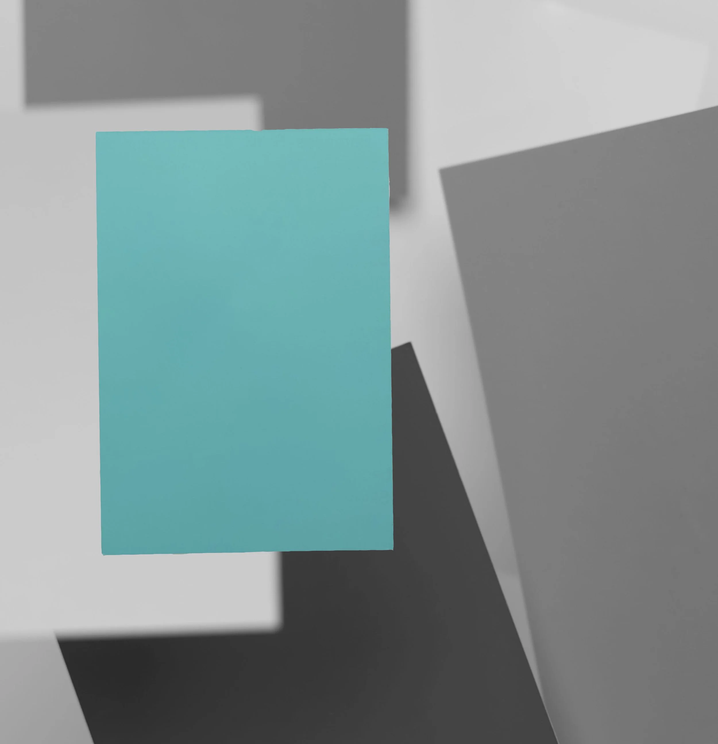 Close-up of a blue post-it note on a gray and black background.