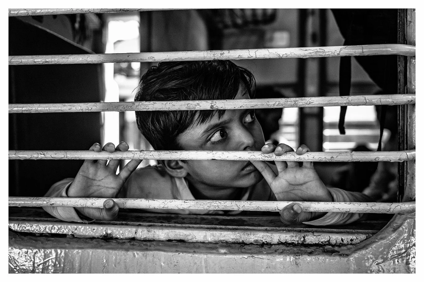 New Delhi Railway Station, day one. This isn&rsquo;t the bullet train to Osaka. It&rsquo;s hotter, rougher, more crowded. It&rsquo;s alive as the windows frame faces with people suspended in between.

Hashtags
#LeicaM11
#StreetPhotographyInternationa