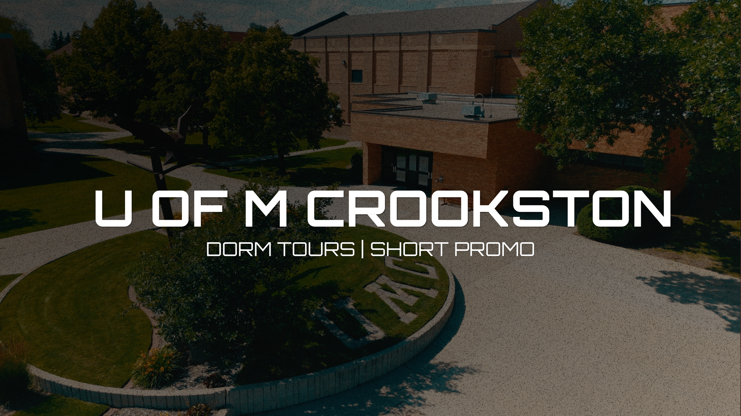 Aerial view of a college campus with trees, parking lot, and a brick building, overlaid with text reading "U OF M CROOKSTON Dorm Tours | Short Promo."