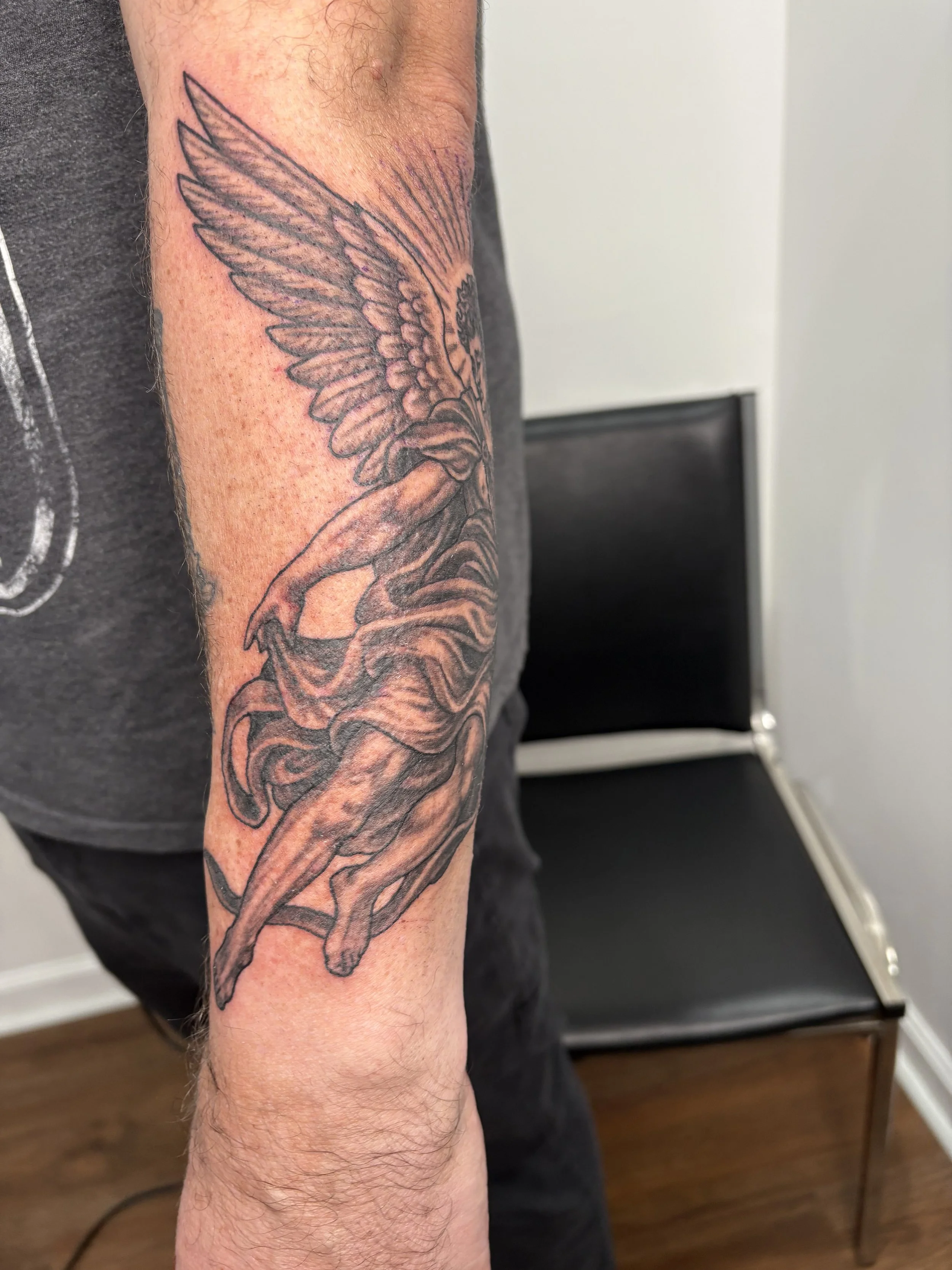 Custom Tattoo of a bird with outstretched wings on a person's forearm. State Of The Art Tattooing Winchester Virginia 