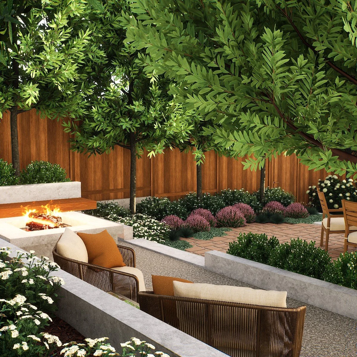 El Segundo backyard with fire pit seating, brick patio, and layered planting in a Mediterranean-inspired landscape design