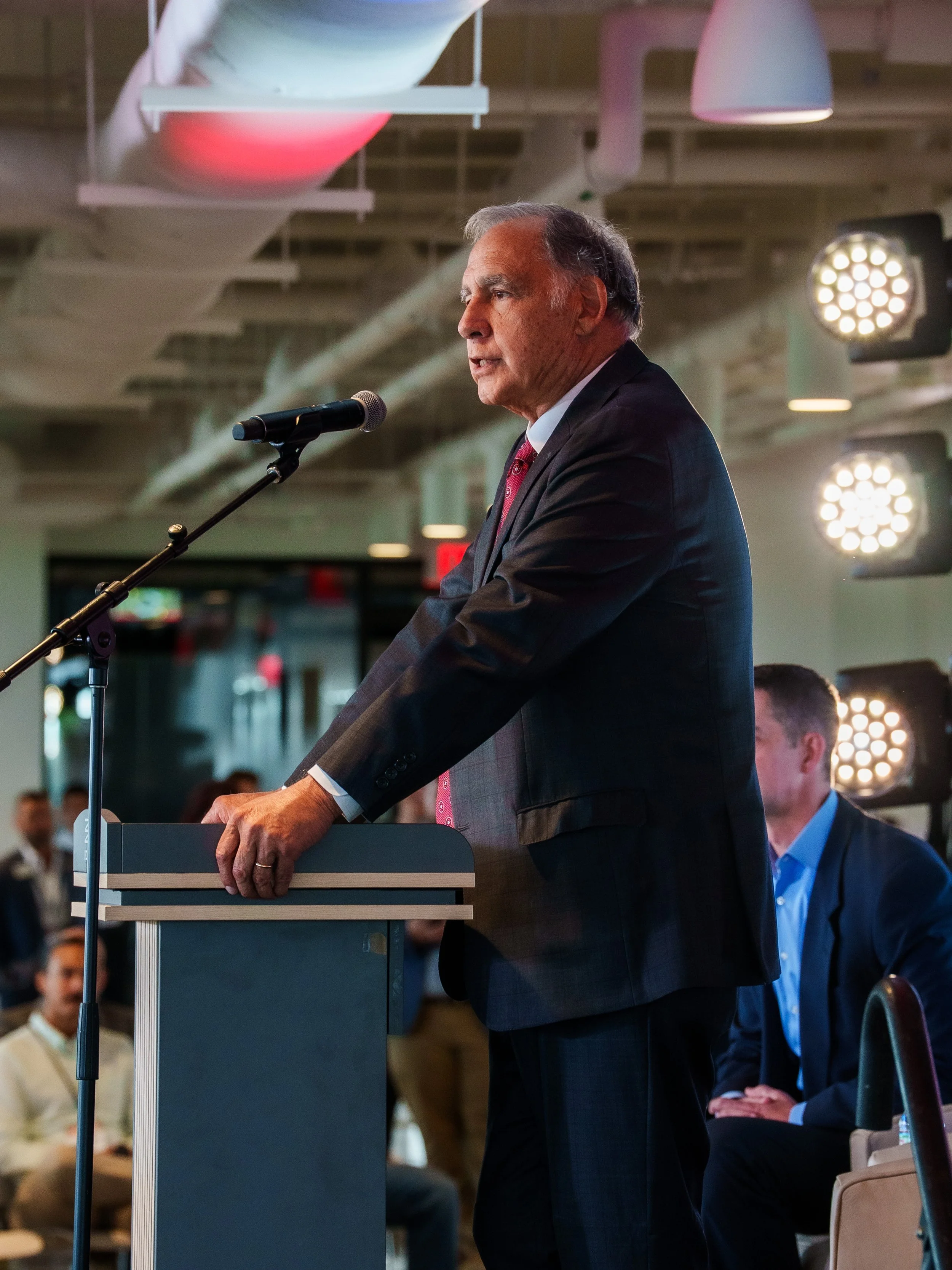 Event photography of John Boozeman speaking at the Made in America event in Northwest Arkansas hosted by the University of Arkansas.