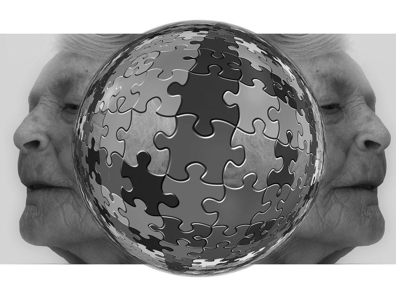 A black and white photo. A globe jigsaw with the pices making no recogniseable image, just shades of gray. On either side of the globe is the same elderly face looking in opposite directions.