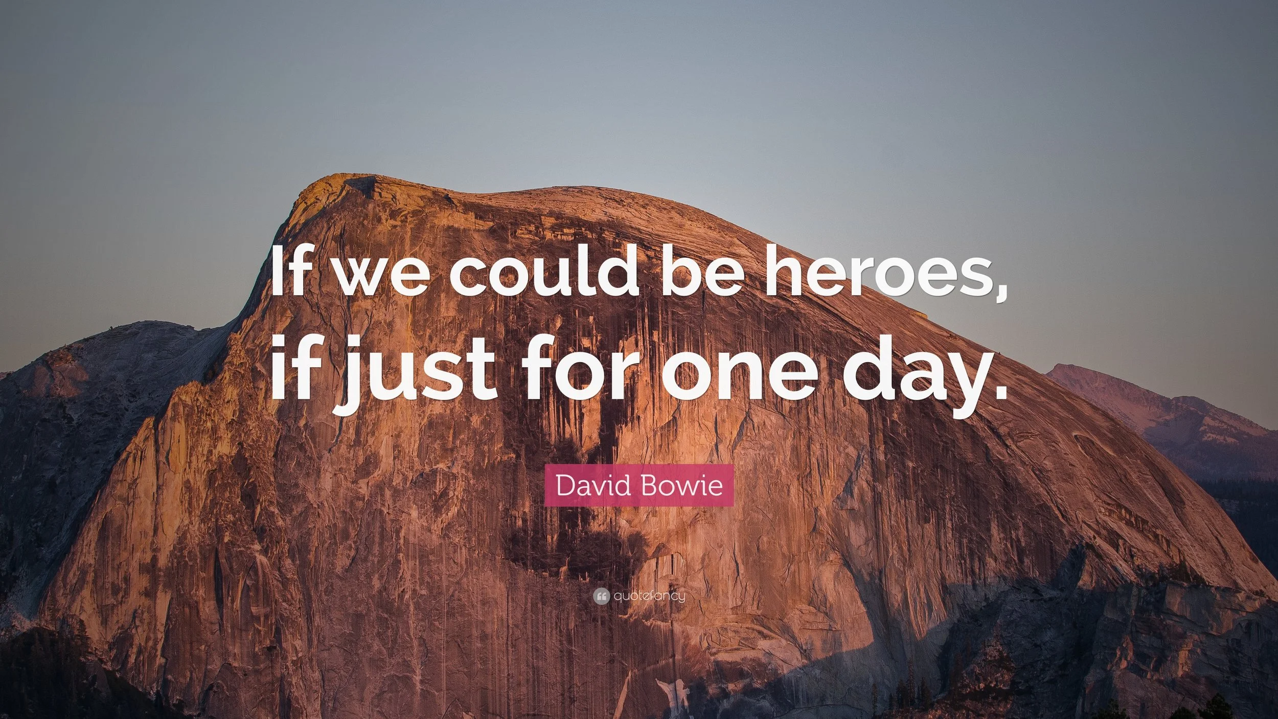 A moutain with the quote "If we could be heroes, if just for one day" from David Bowie over it