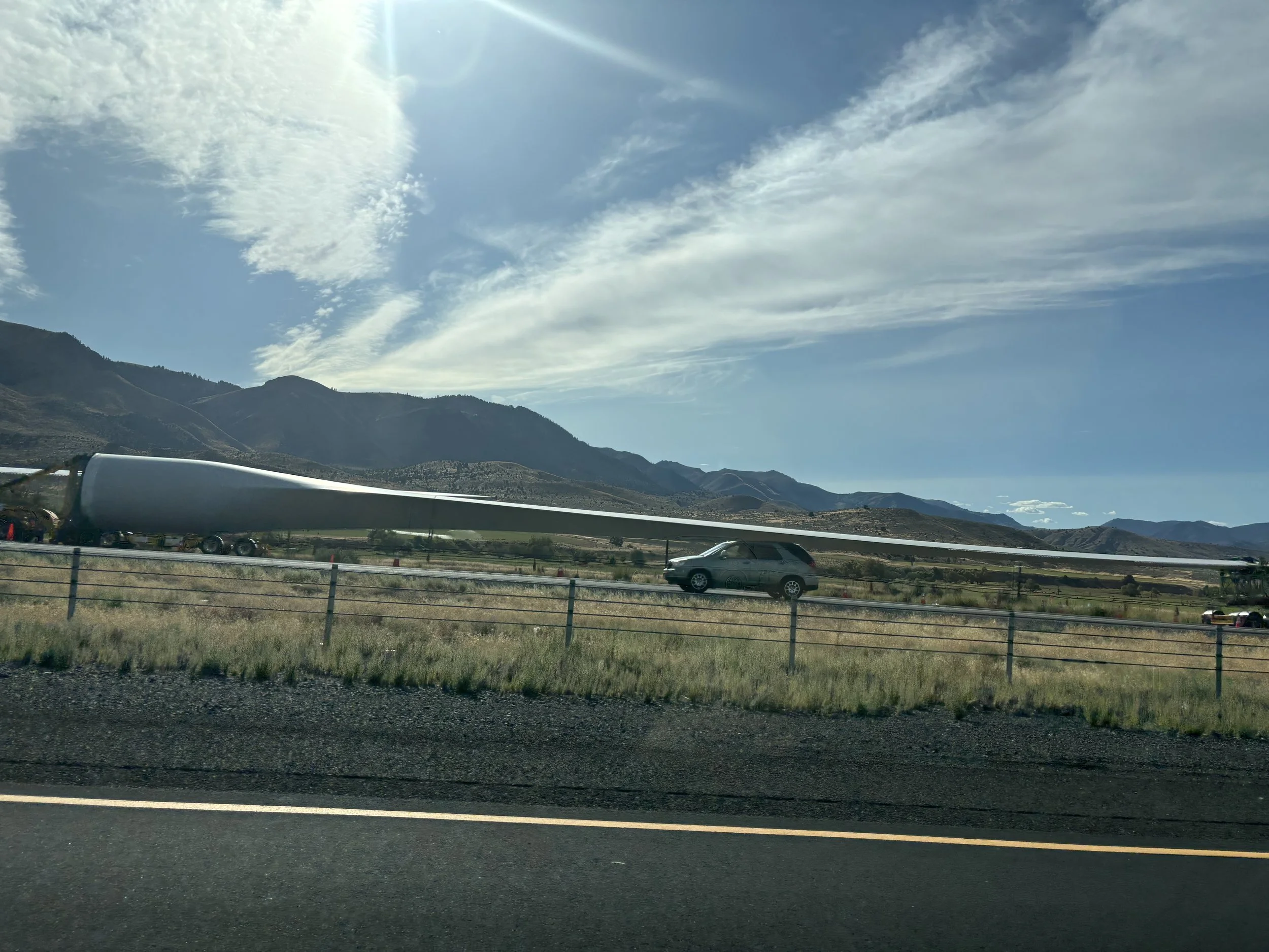 A truck towing a blade for a windmill. Couldn't fit the whole thing in the frame.