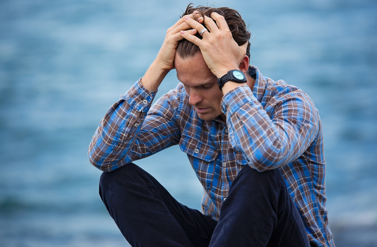 Depression Doesn't Take a Summer Vacation, man sitting by water