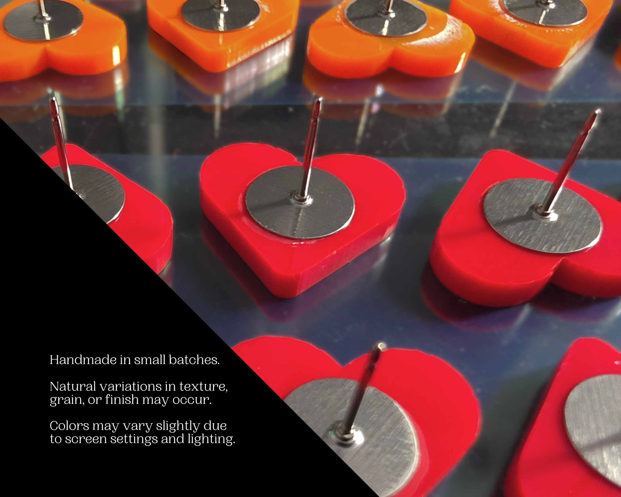 Small-batch handmade production of orange and red acrylic heart stud earrings, with note about natural variations in texture, grain, and finish