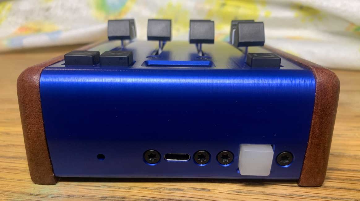 The back view of a blue anodized aluminum custom programmable MIDI fader