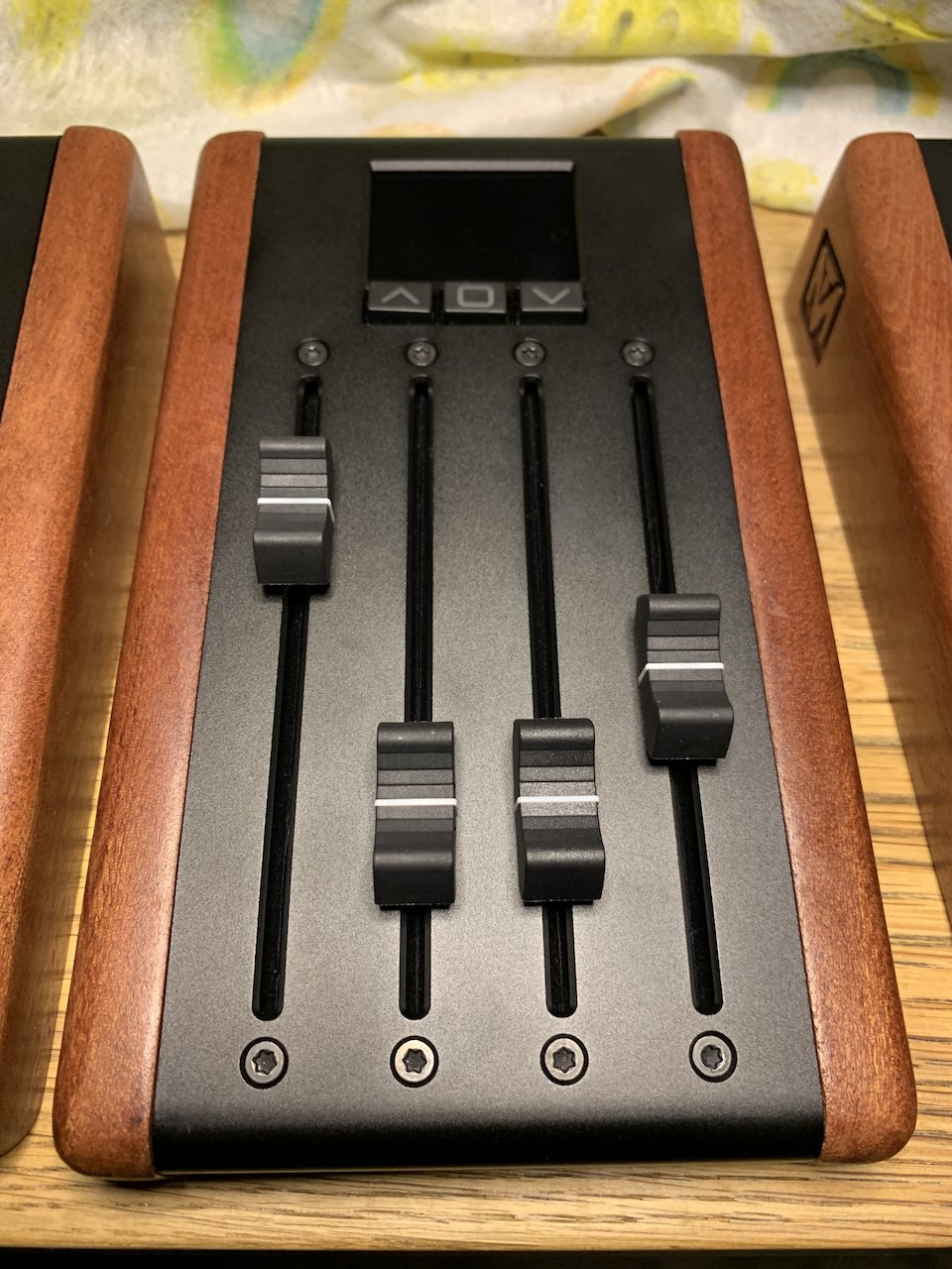 A view of programmable MIDI faders with wood and metal