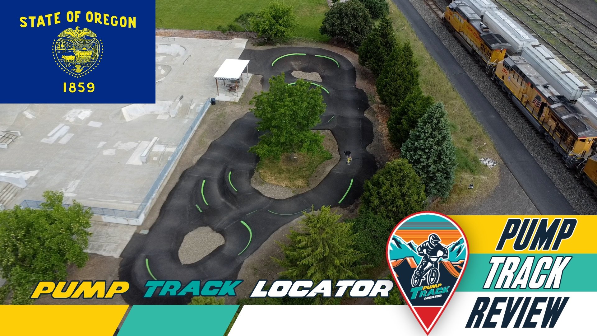 A small pump track with winding asphalt paths, a central tree, surrounded by several smaller trees, located next to a train track with yellow passenger trains. There is a person riding a bike on the track, and a person standing nearby. The image also includes logos and text for Oregon's state seal and a pump track review.