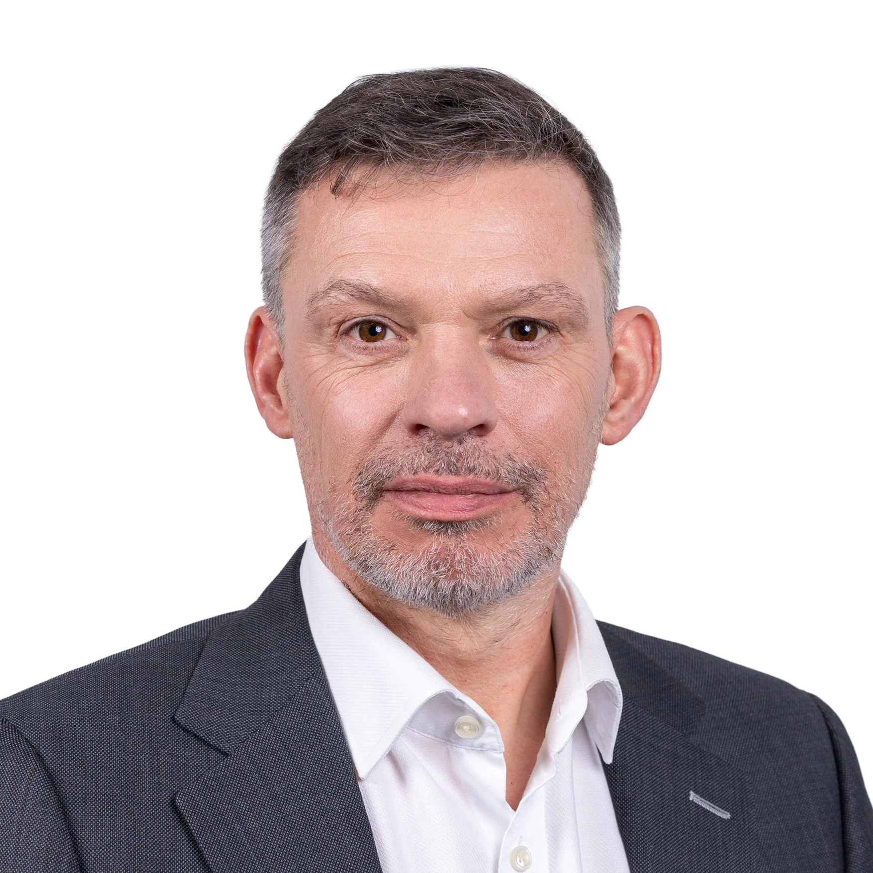 Man in white shirt but grey suit jacket taking part in a business headshot on a white backdrop, taken on location on Regent Street, Mayfair