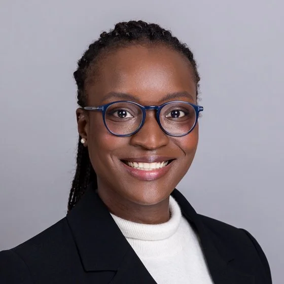 Team headshot of a lady in a black blazer and white jumper. Shot By Andrew Corporate Headshot taken in a onsite studio