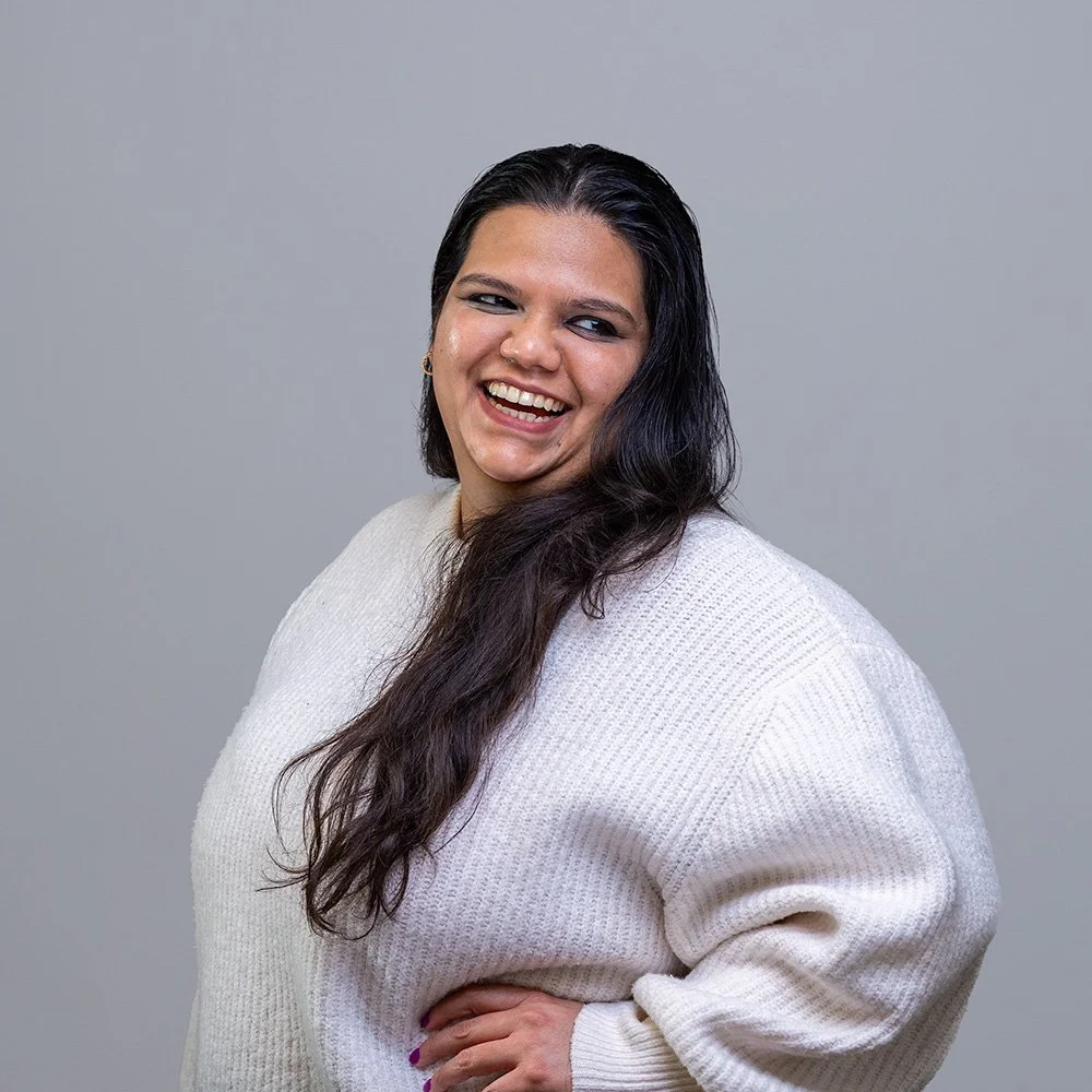 Woman laughing naturally during a LinkedIn headshot session in London studio — relaxed guided professional photography | Shot By Andrew